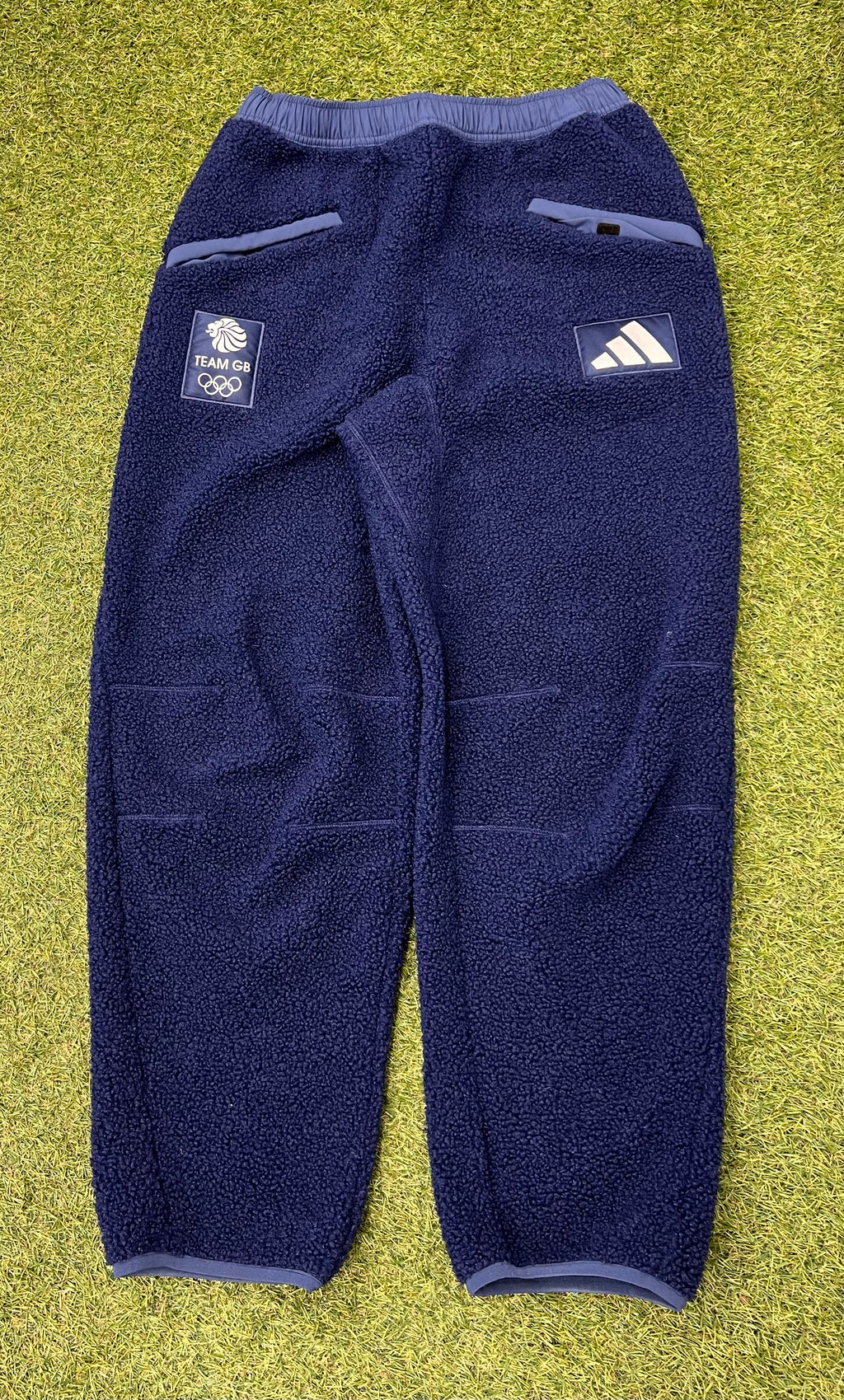 Front view of adidas Team GB navy fleece trousers with pockets and logo patches