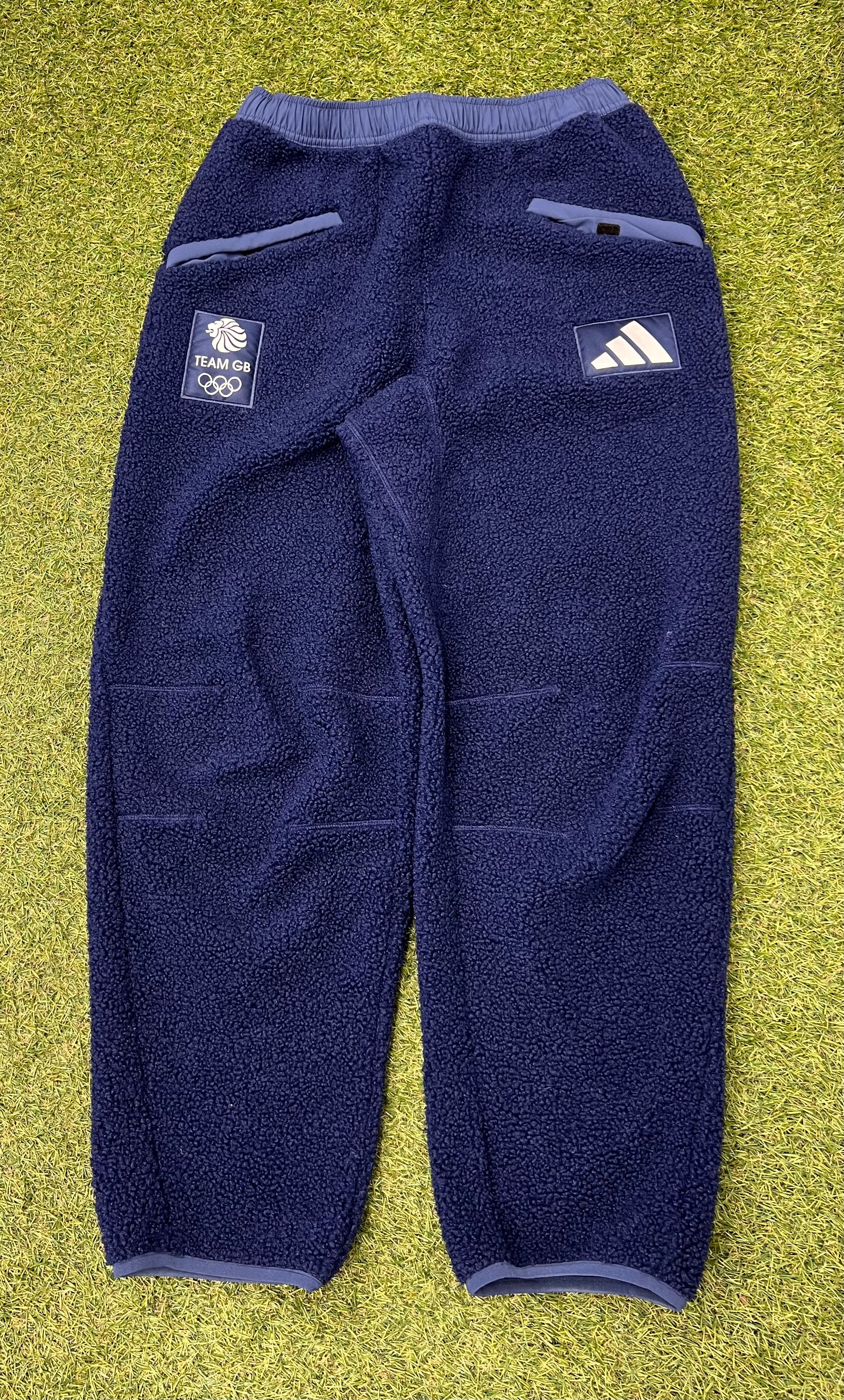 Front view of adidas Team GB navy fleece trousers with pockets and logo patches