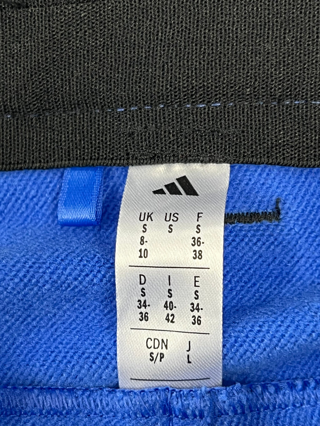 Close-up image of adidas size label showing size small UK 8-10