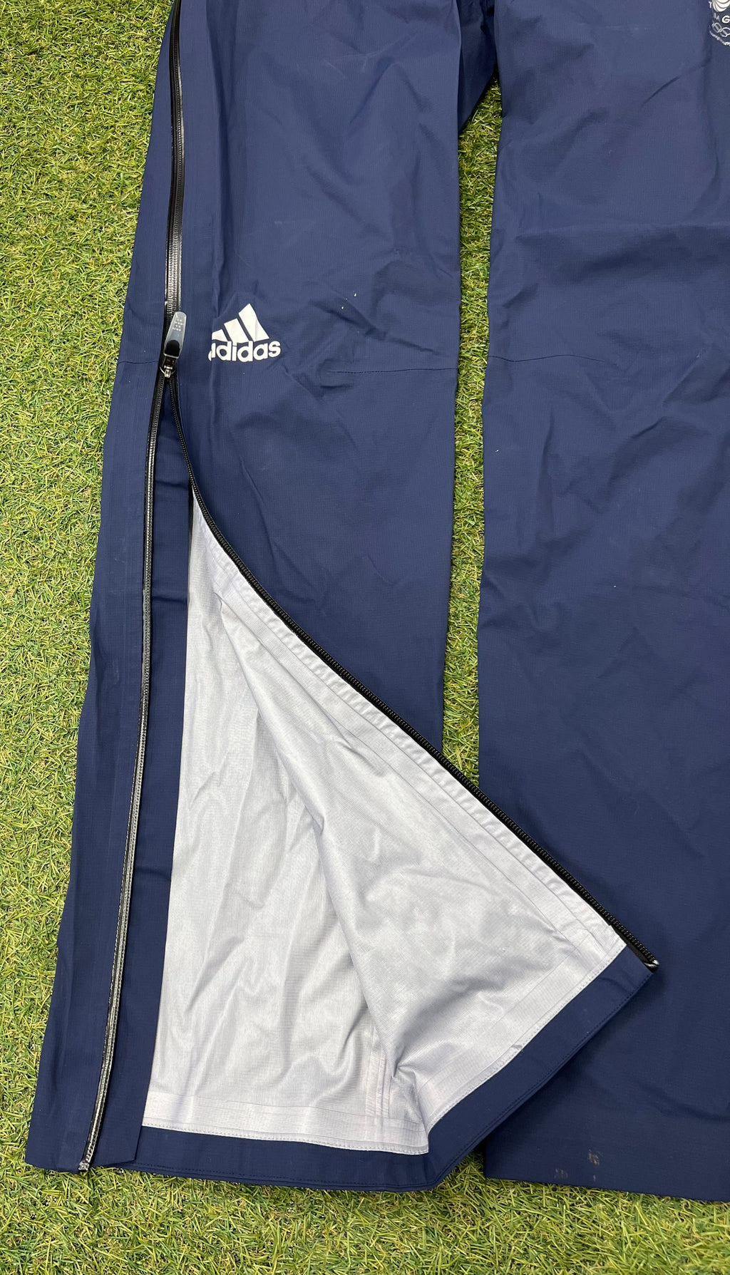 Close up of navy waterproof trousers unzipped to reveal inner lining and taped seams