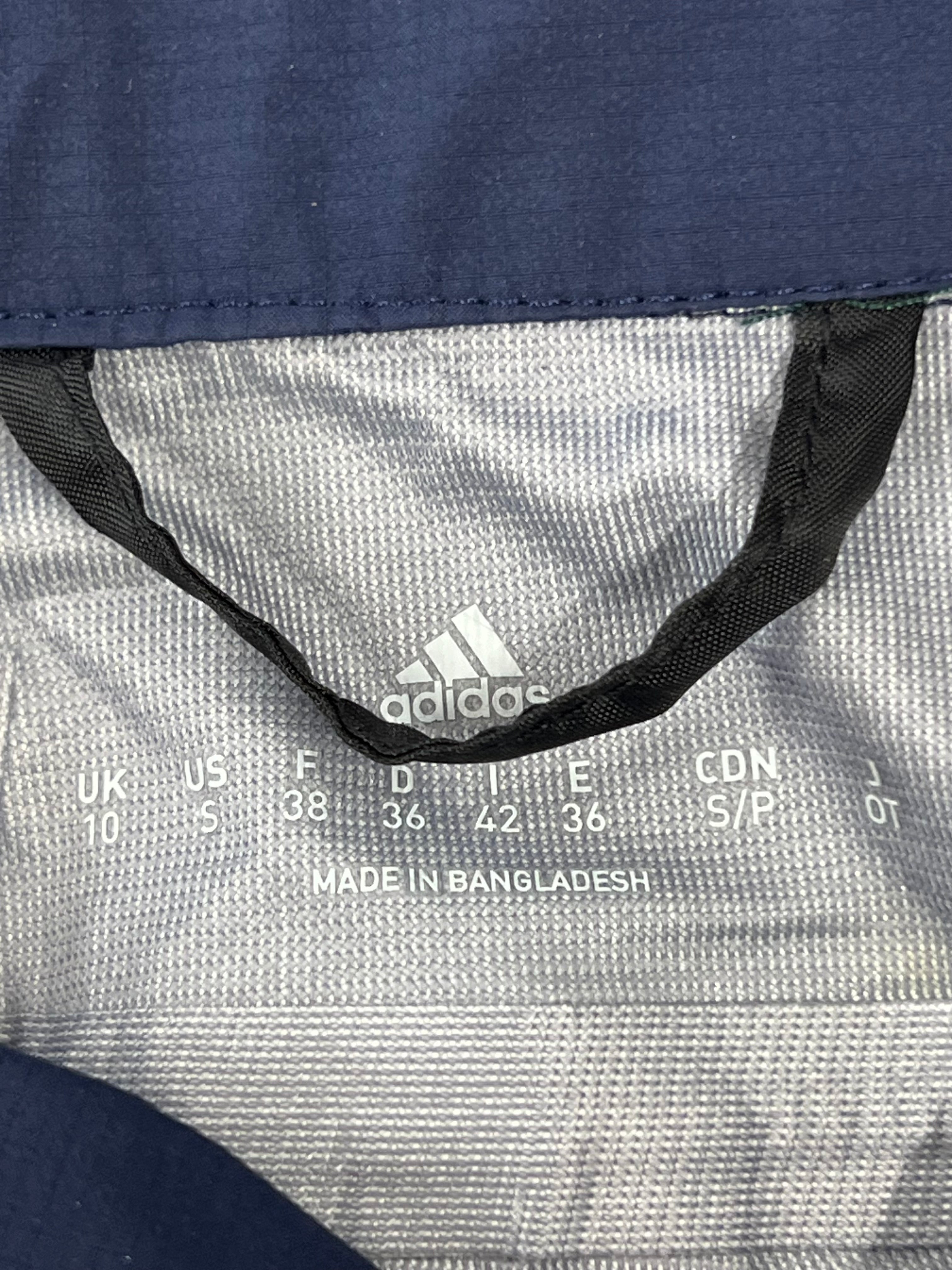 Size and material label inside adidas waterproof trousers stating UK size 10 and made in Bangladesh