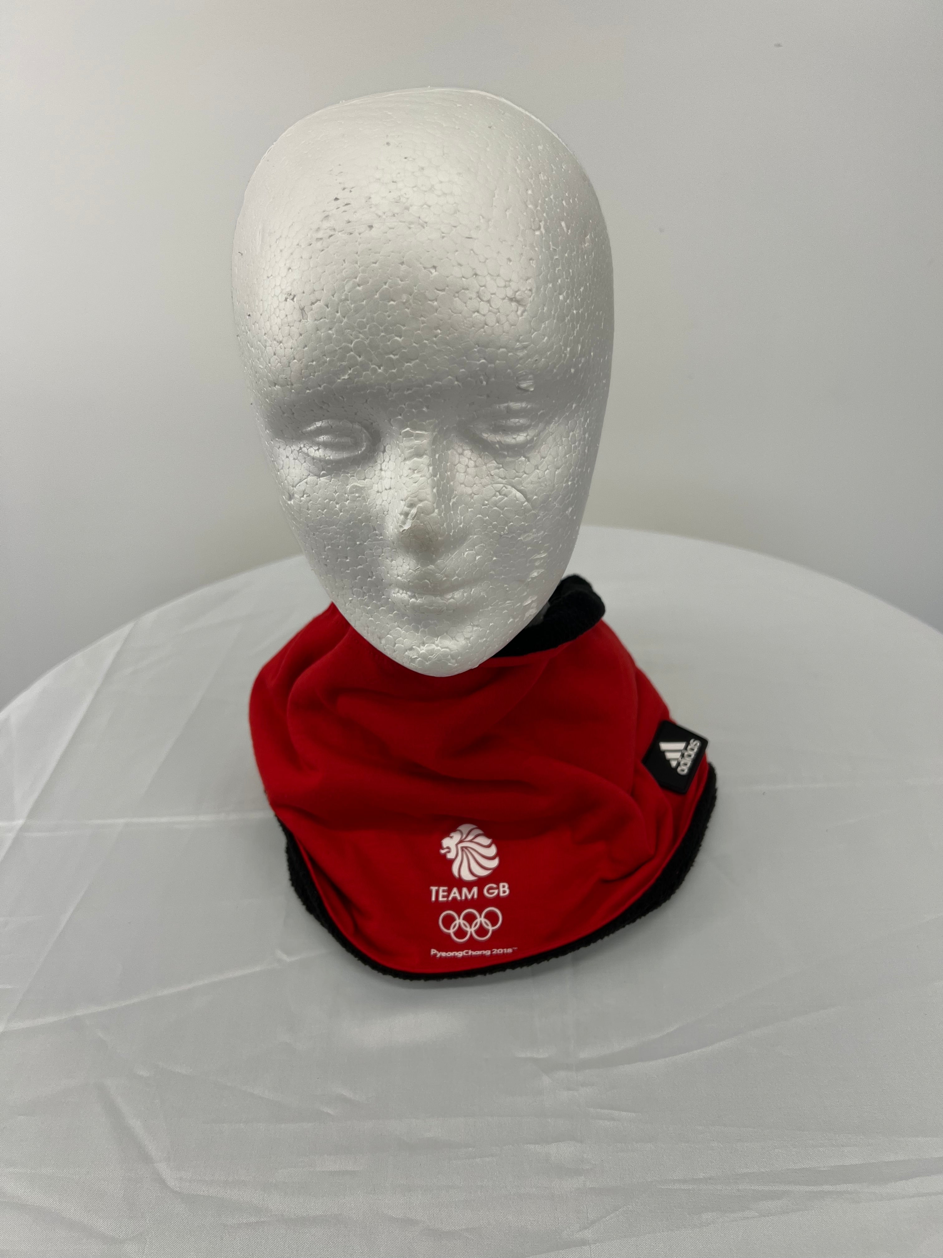 Interior view of black fleece lining of neck warmer with Adidas sizing label