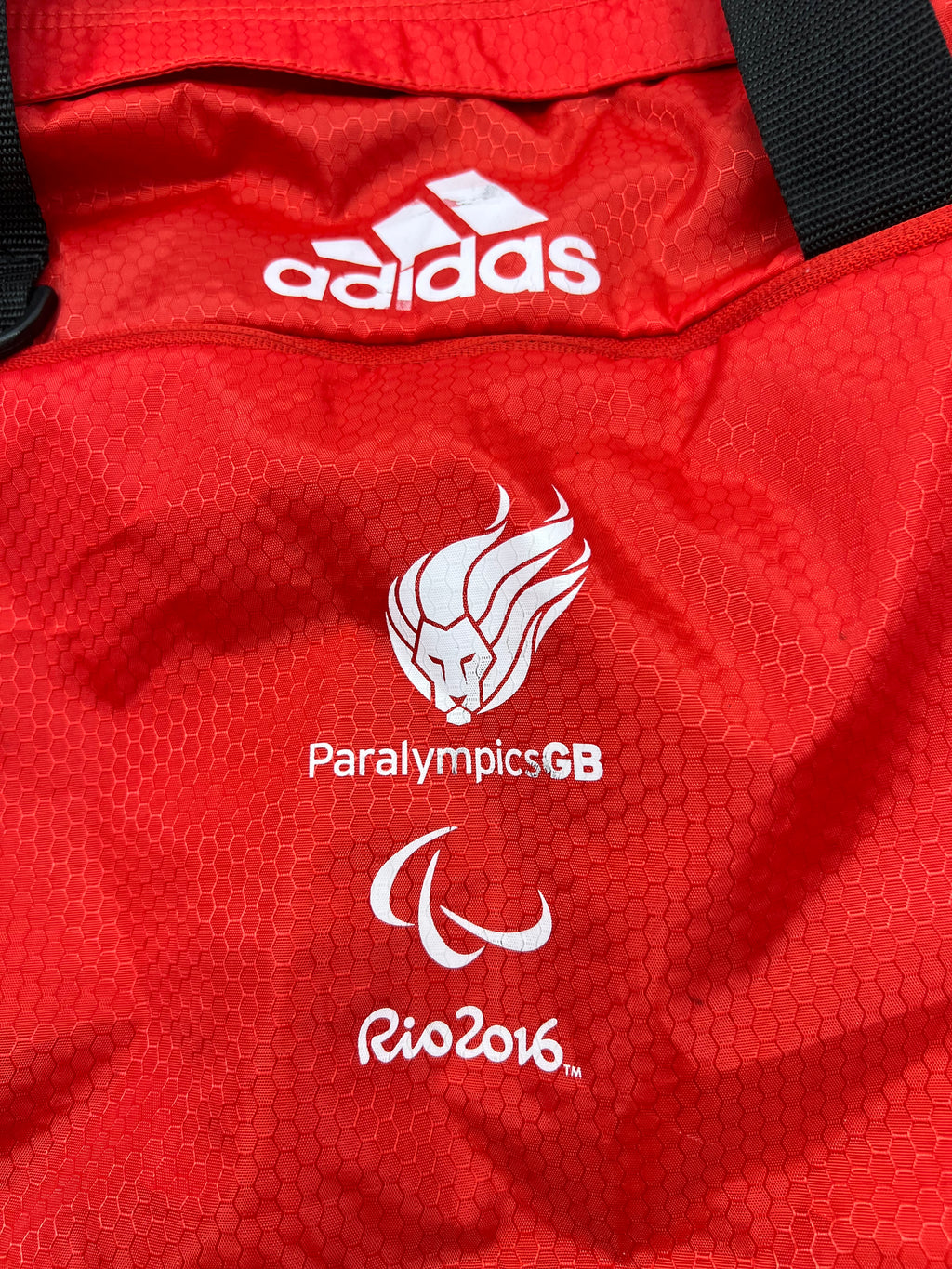 Close up of Adidas logo and Paralympics GB Rio 2016 logos on red fabric