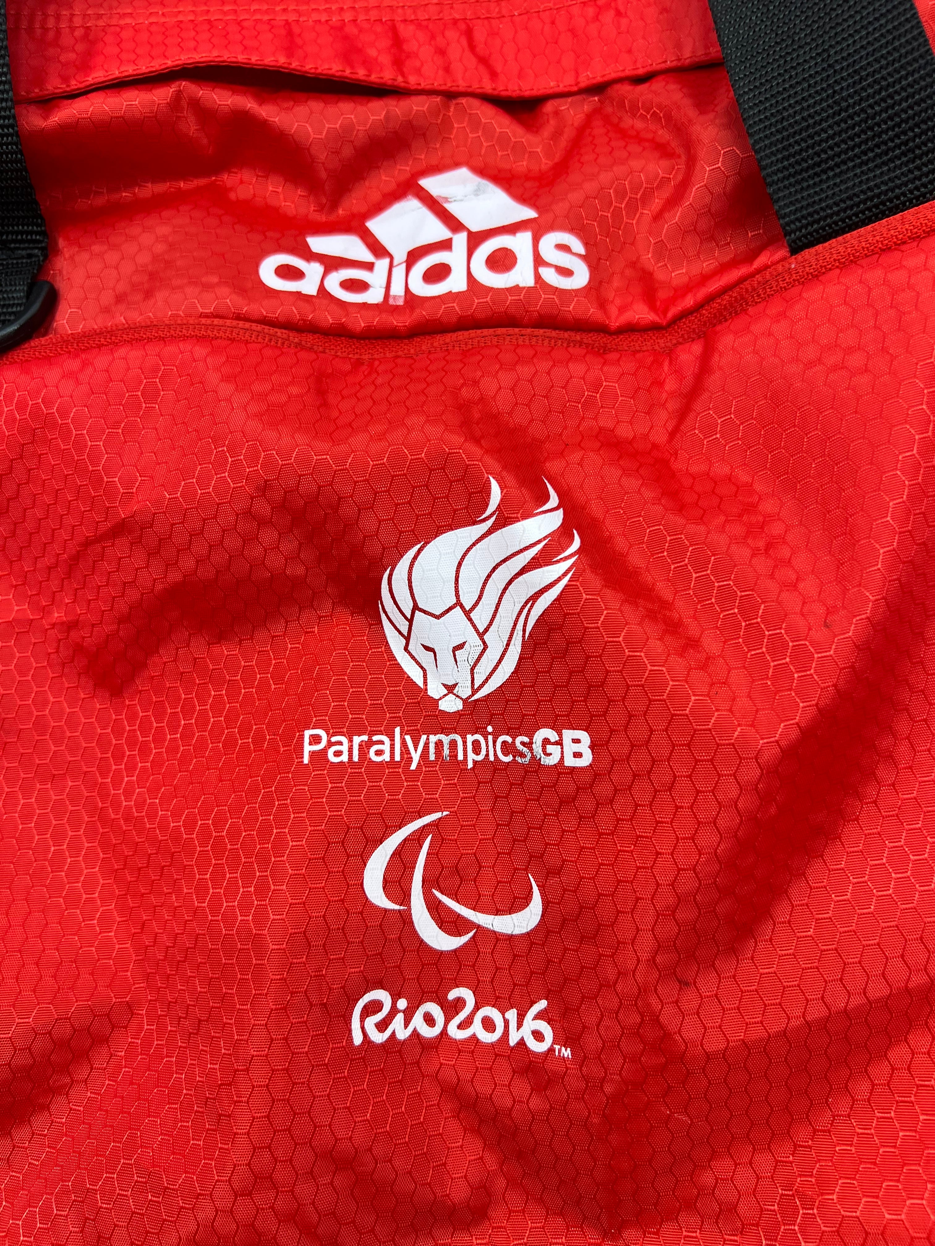 Close up of Adidas logo and Paralympics GB Rio 2016 logos on red fabric