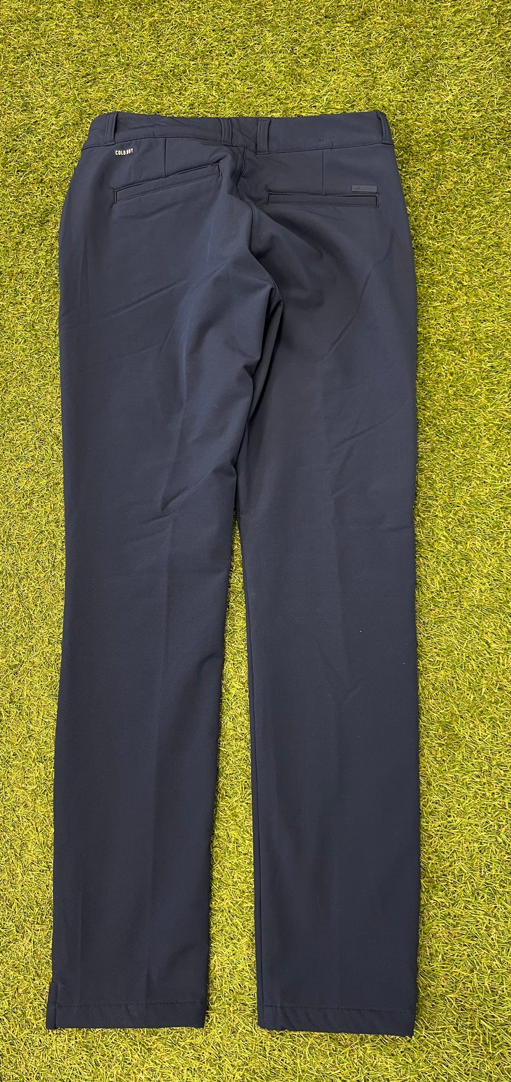 Adidas Team GB women's fleece-lined navy trousers back view with pockets on grass