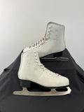 Side view of white Oxelo women’s figure skates showing laces, ankle support, and blades