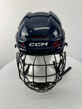 Front view of navy CCM Tacks 70 youth hockey helmet with black face guard