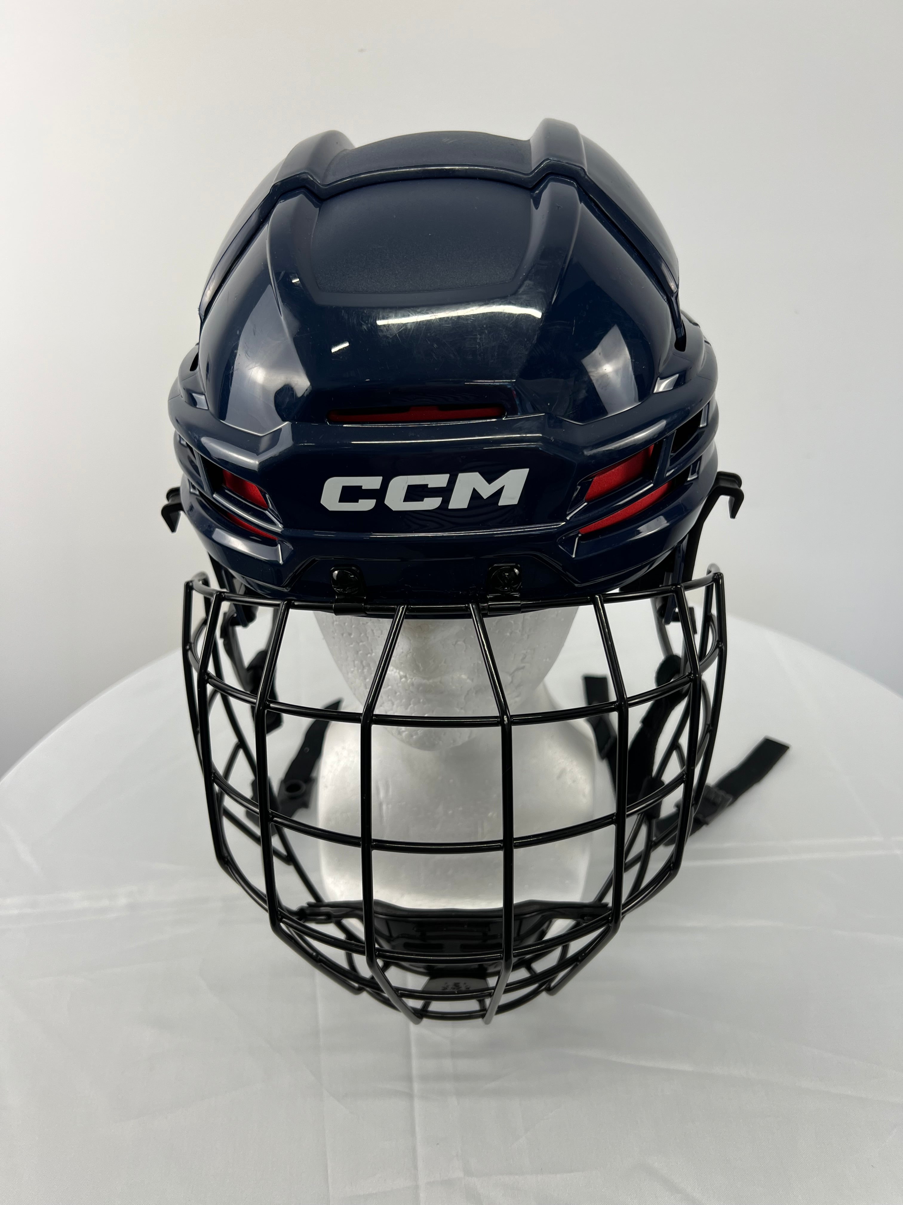 Front view of navy CCM Tacks 70 youth hockey helmet with black face guard