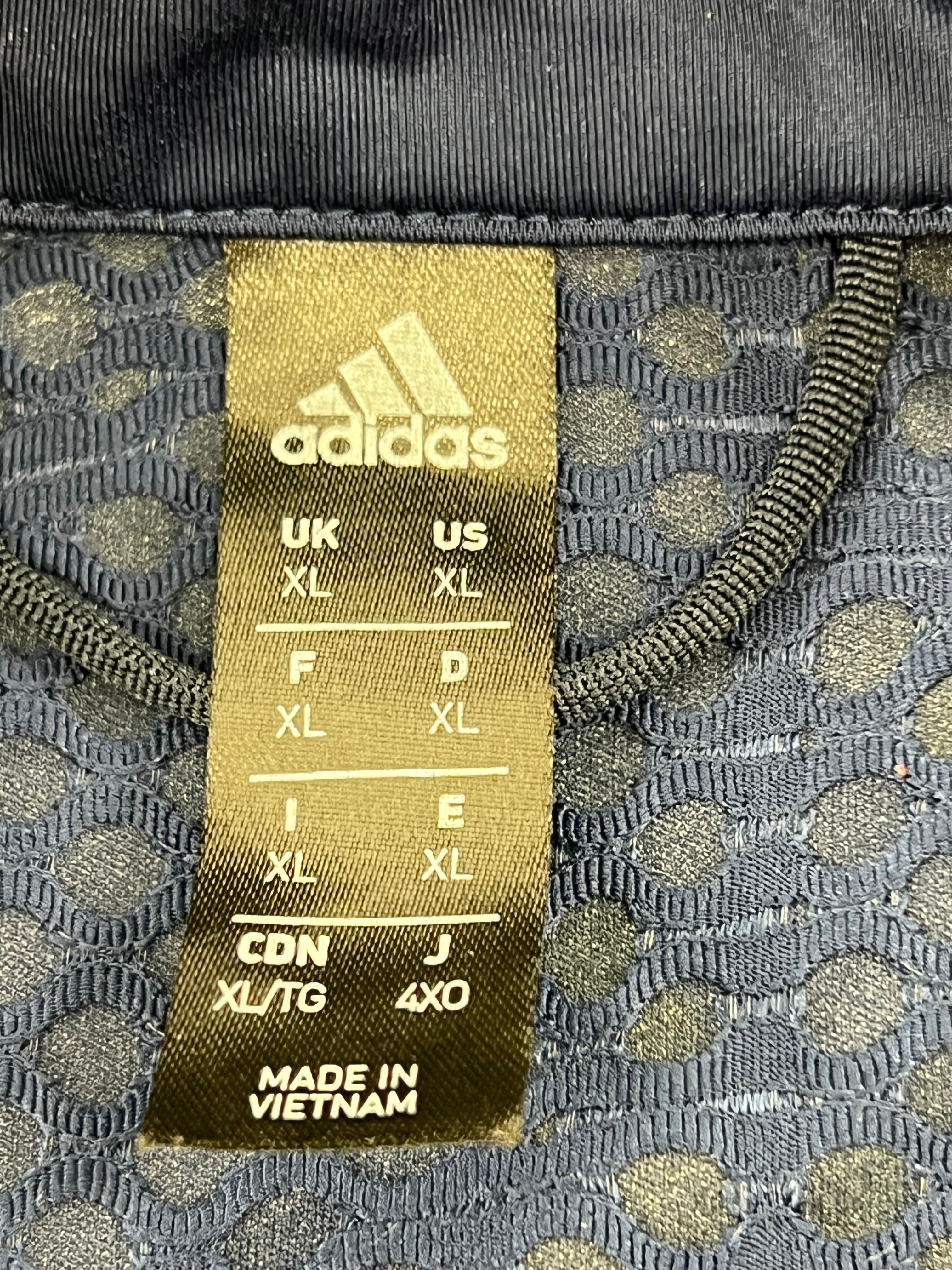 Adidas size label inside gilet showing XL size and made in Vietnam