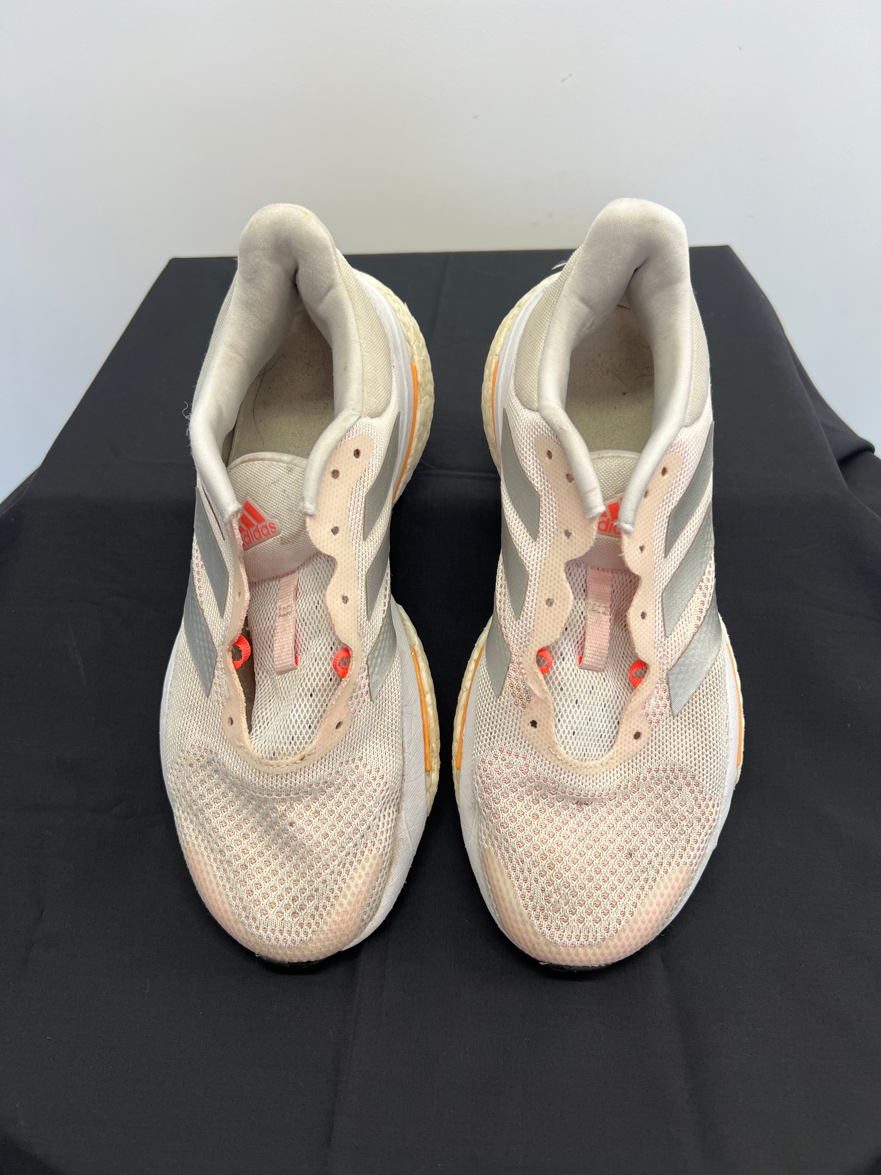 Top view of beige adidas Solar Glide running shoes without laces