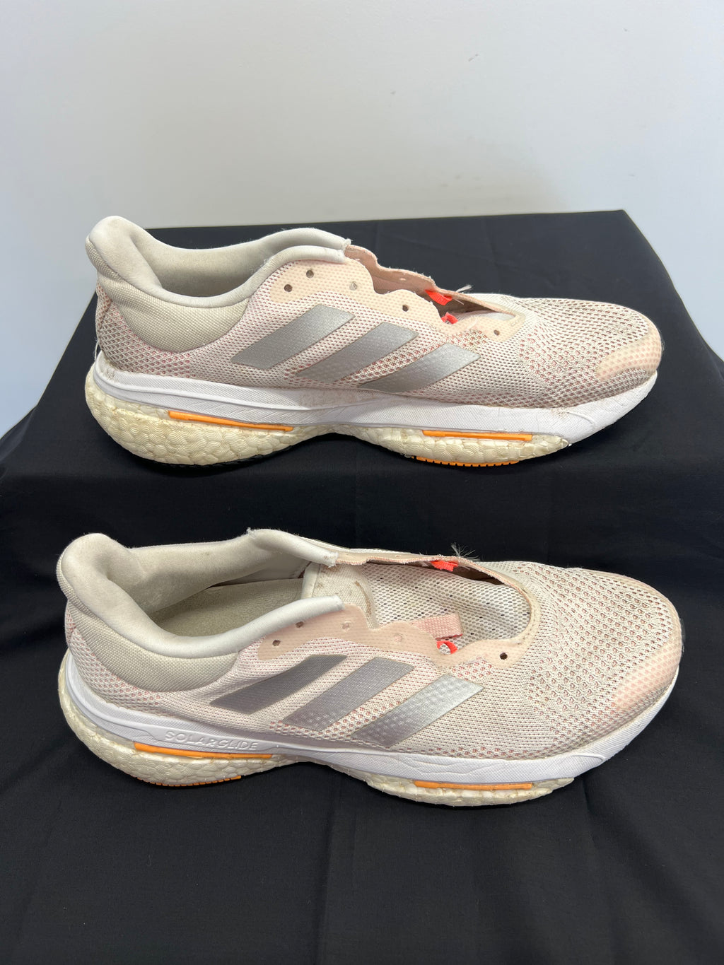 Side view of beige adidas Solar Glide running shoes showing mesh upper and Boost midsole