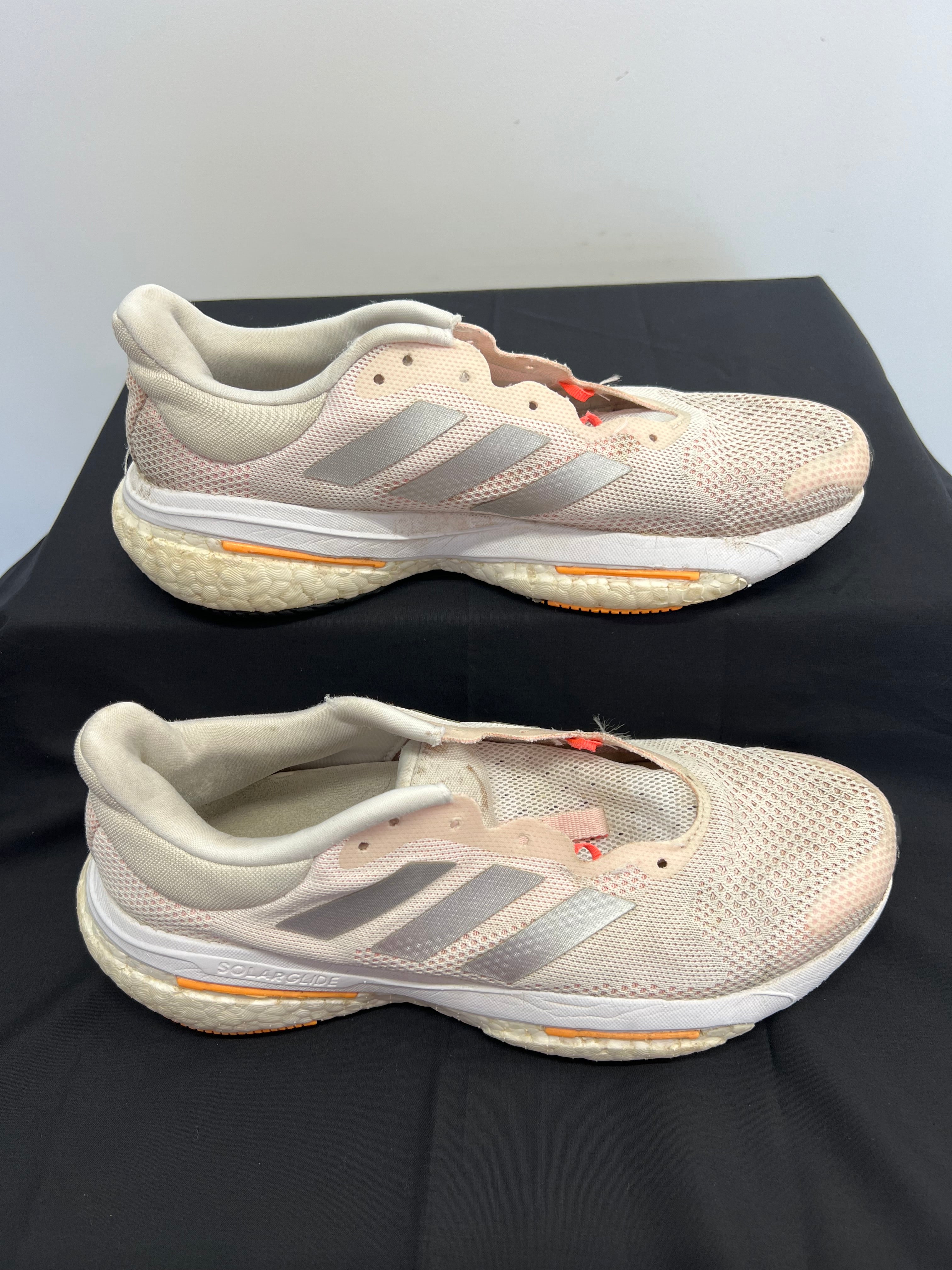 Side view of beige adidas Solar Glide running shoes showing mesh upper and Boost midsole