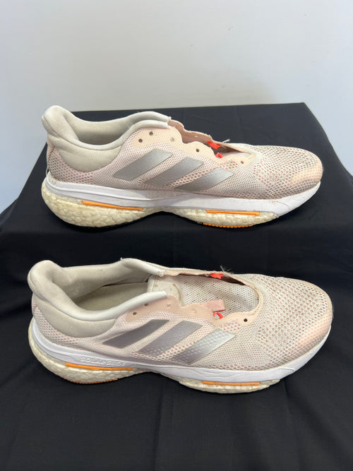 Side view of beige adidas Solar Glide running shoes showing mesh upper and Boost midsole