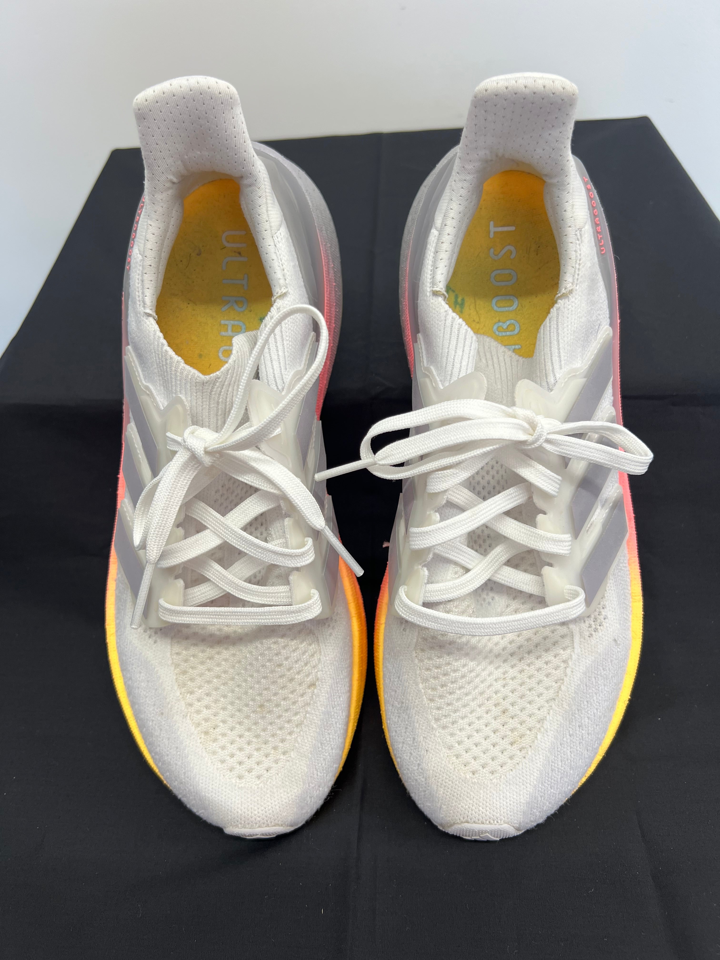Top view of adidas Ultra Boost Light Boost trainers in white with yellow to pink gradient sole