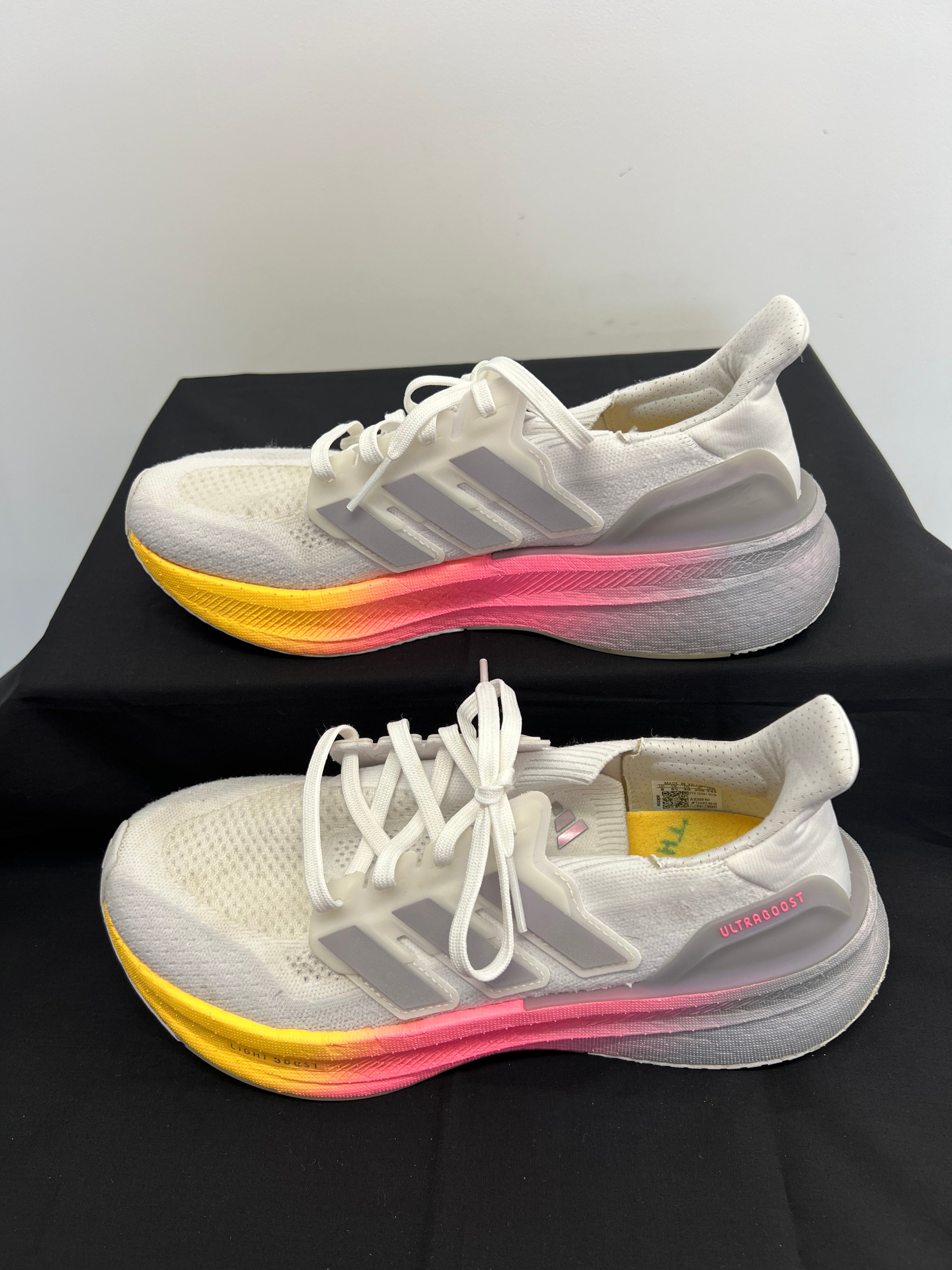 Alternate side view of adidas Ultra Boost trainers highlighting knit upper and gradient sole