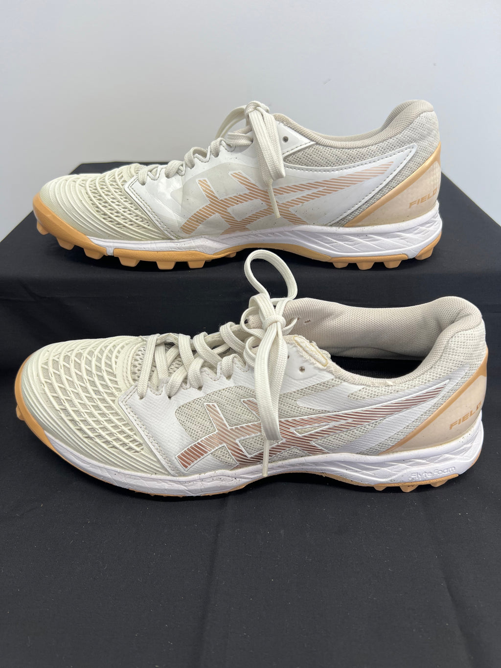 Opposite side profile of hockey shoe highlighting mesh design and studded outsole