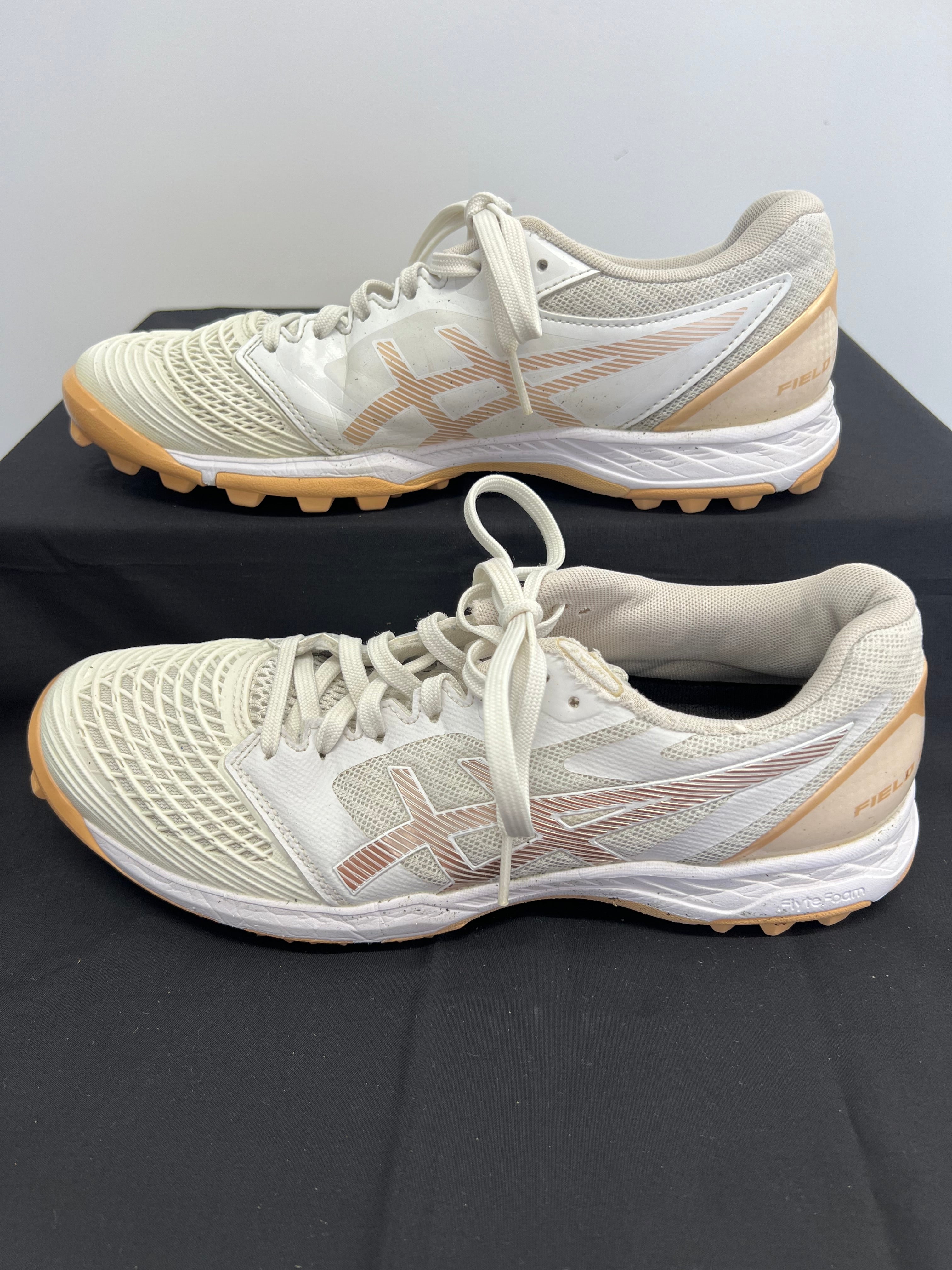 Opposite side profile of hockey shoe highlighting mesh design and studded outsole
