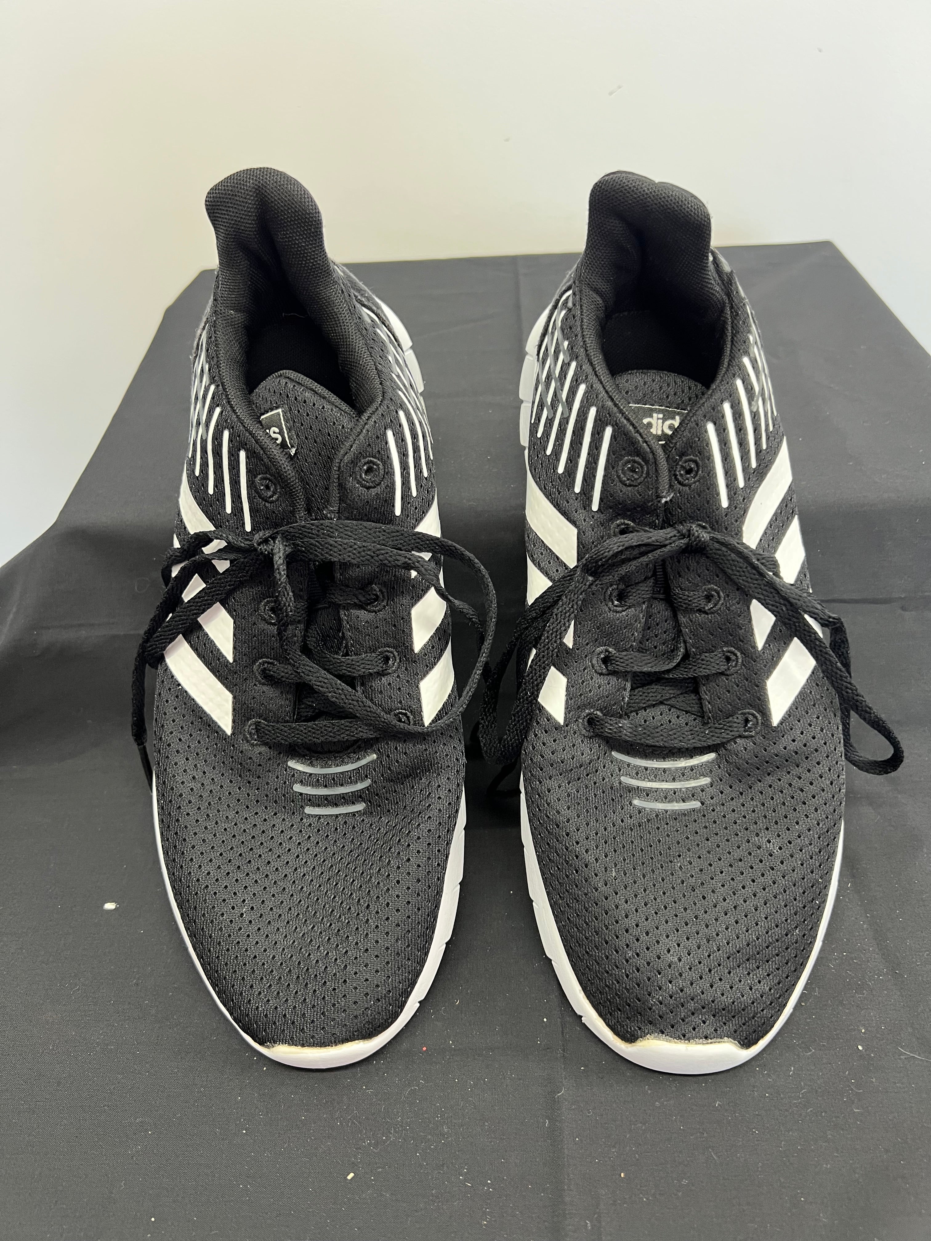 Front view of Adidas Asweerun black running trainers with white stripes and laces