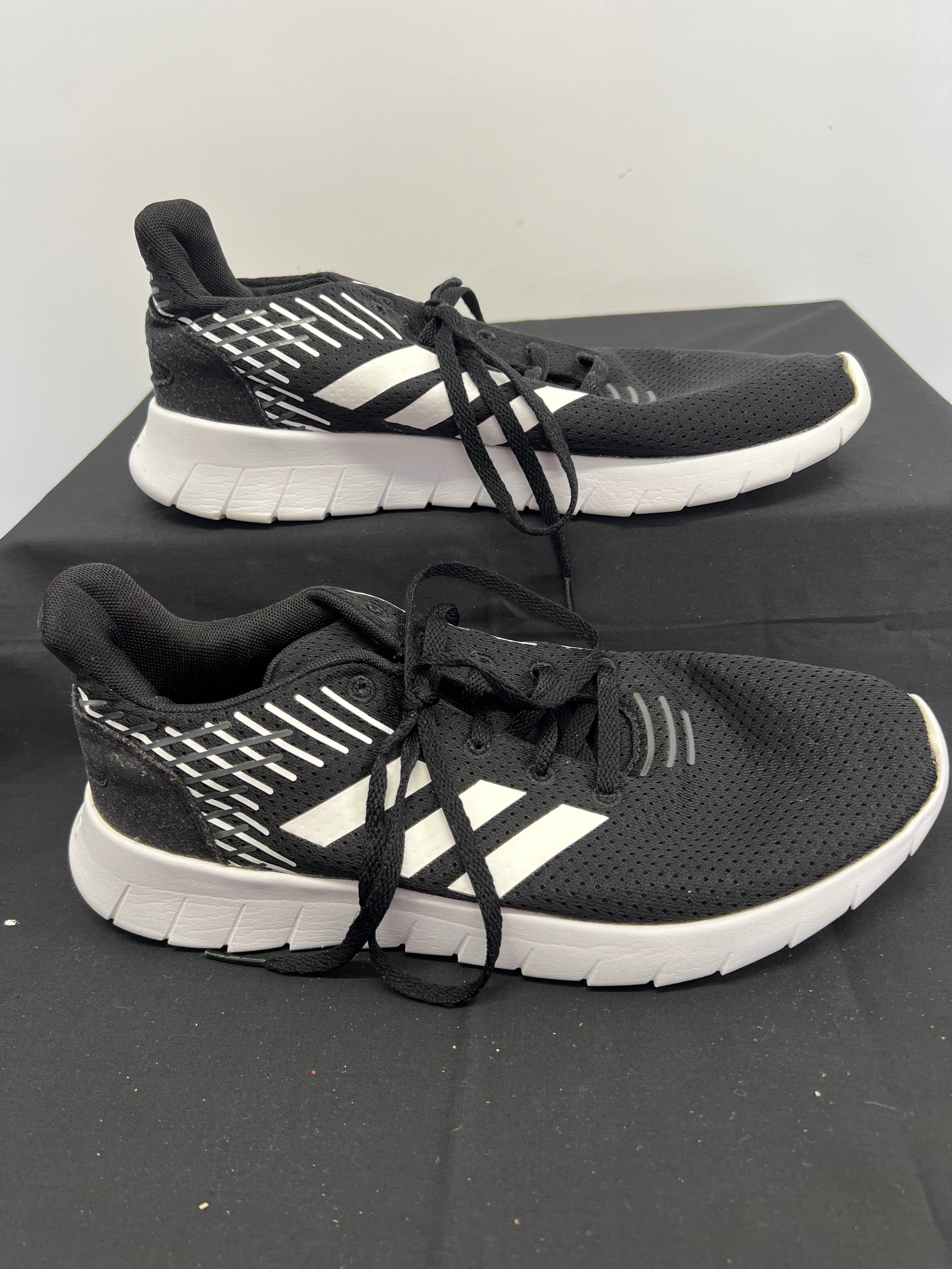 Side view of Adidas Asweerun running trainer showing breathable mesh upper and flexible white sole