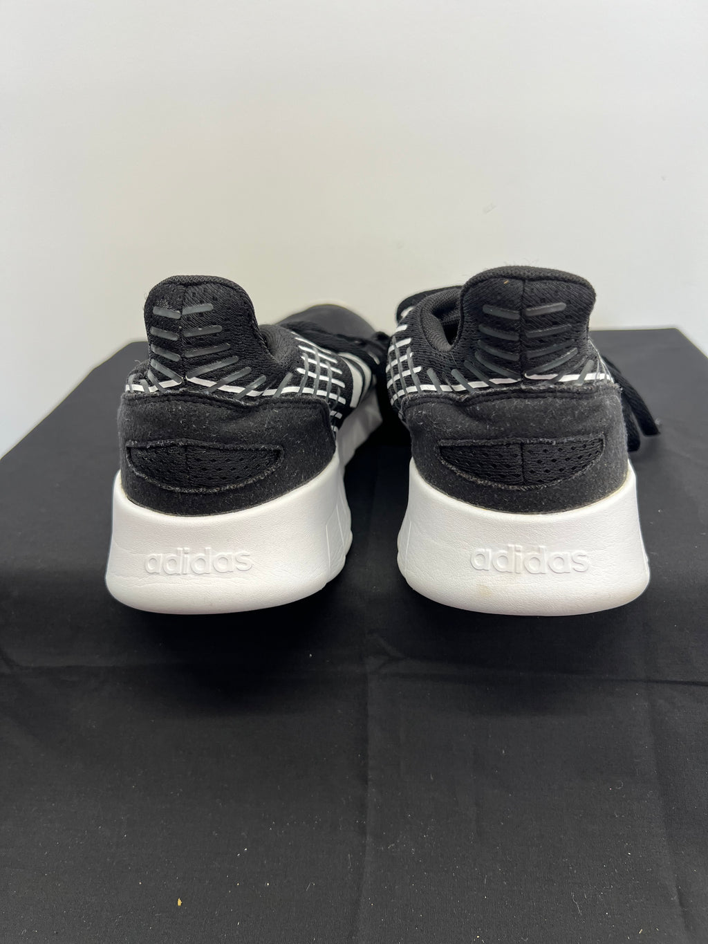 Rear view of Adidas Asweerun trainers featuring padded collar and Adidas logo on heel