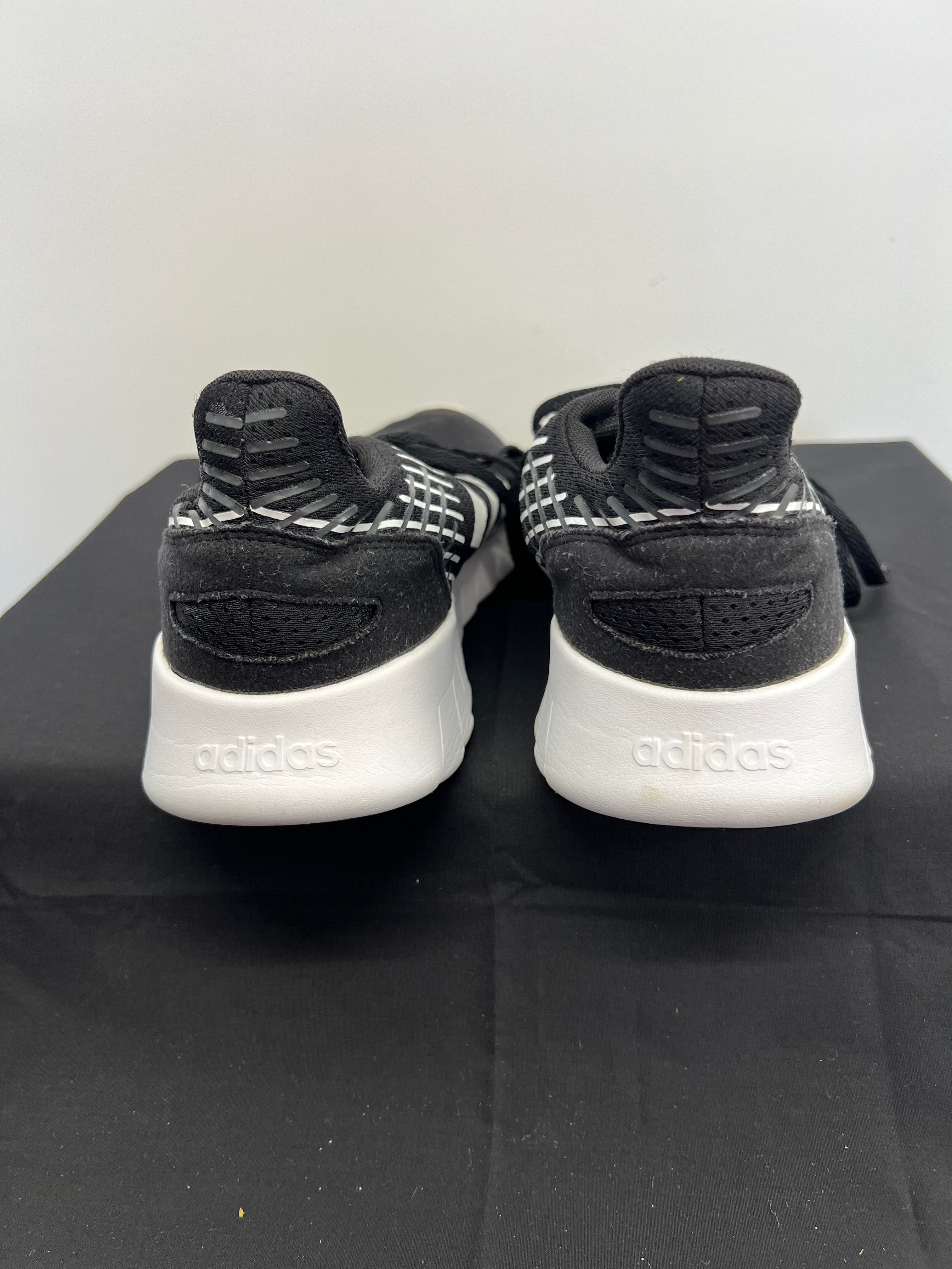 Rear view of Adidas Asweerun trainers featuring padded collar and Adidas logo on heel