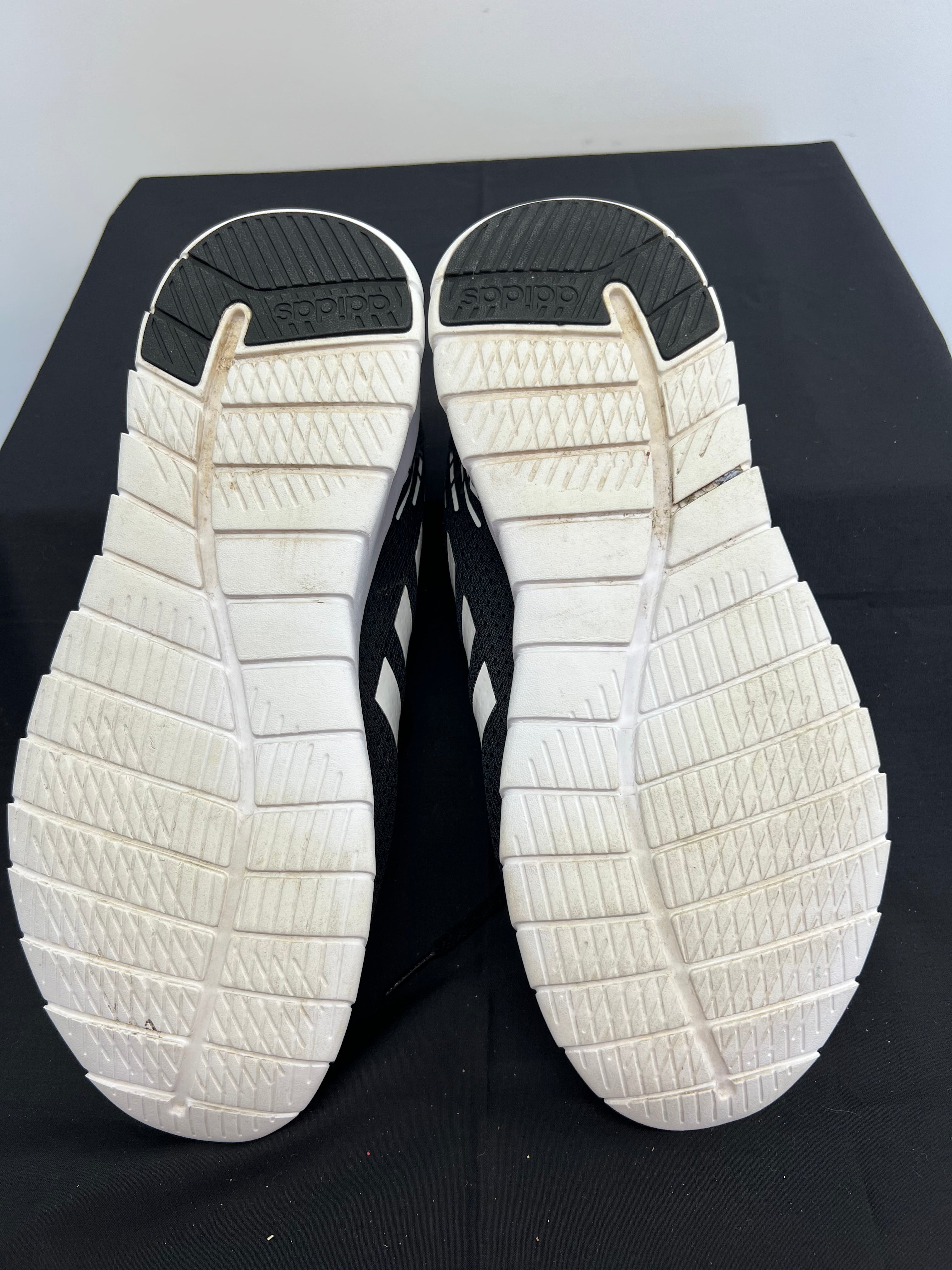 Sole view of Adidas Asweerun running trainers with grip patterns and Adidas branding