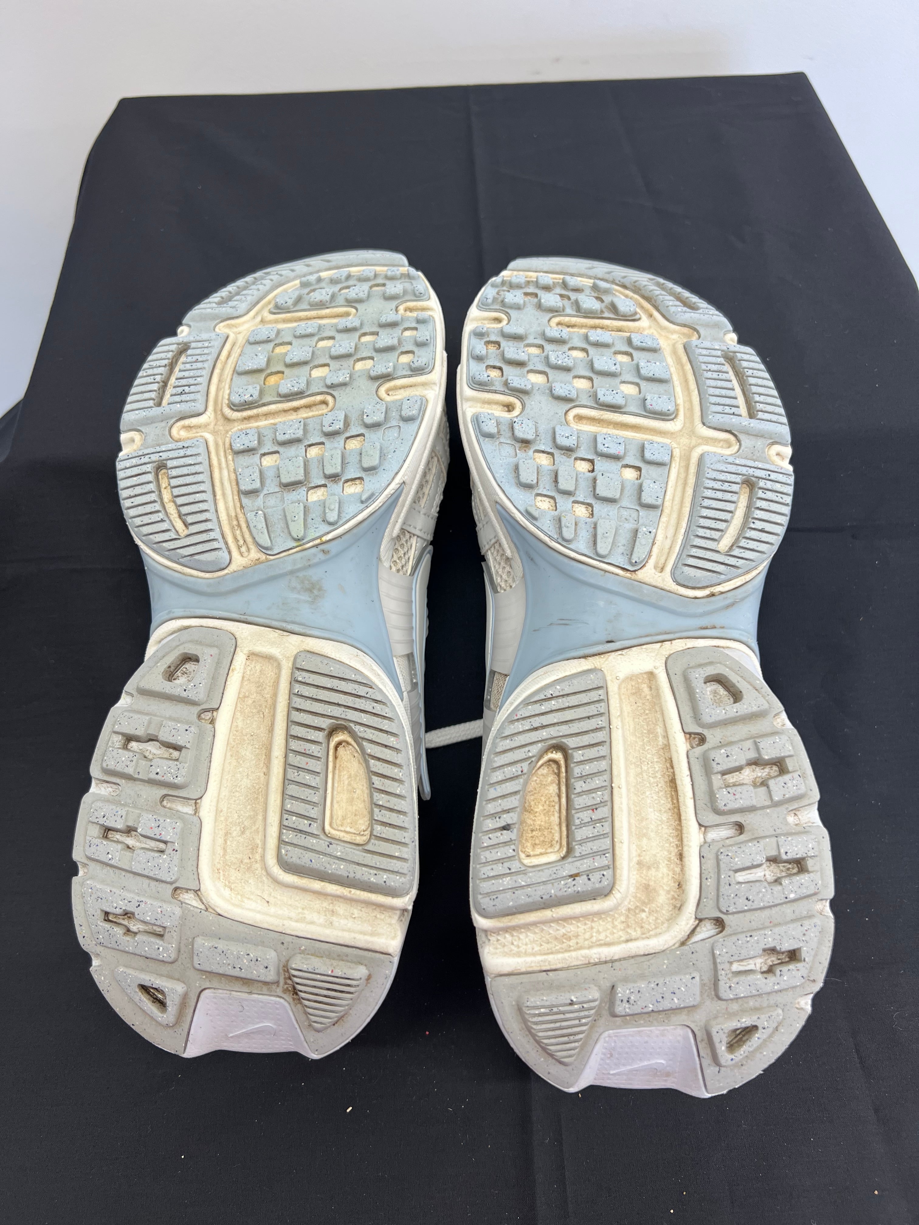 Soles of Nike V2K Run trainers showing tread pattern and wear
