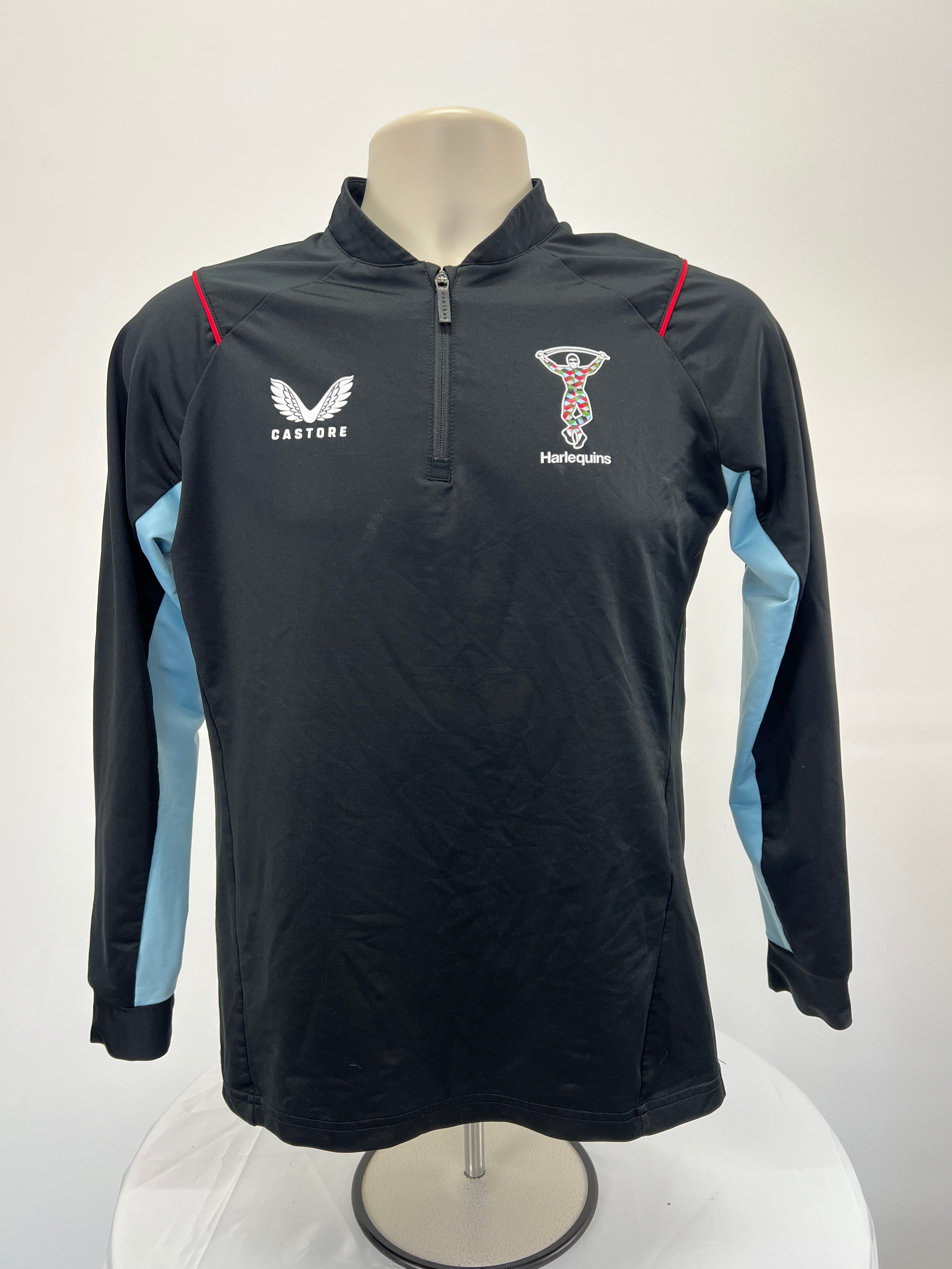 Front view of Castore Harlequins women's long-sleeve black training top with light blue sleeve panels and red piping