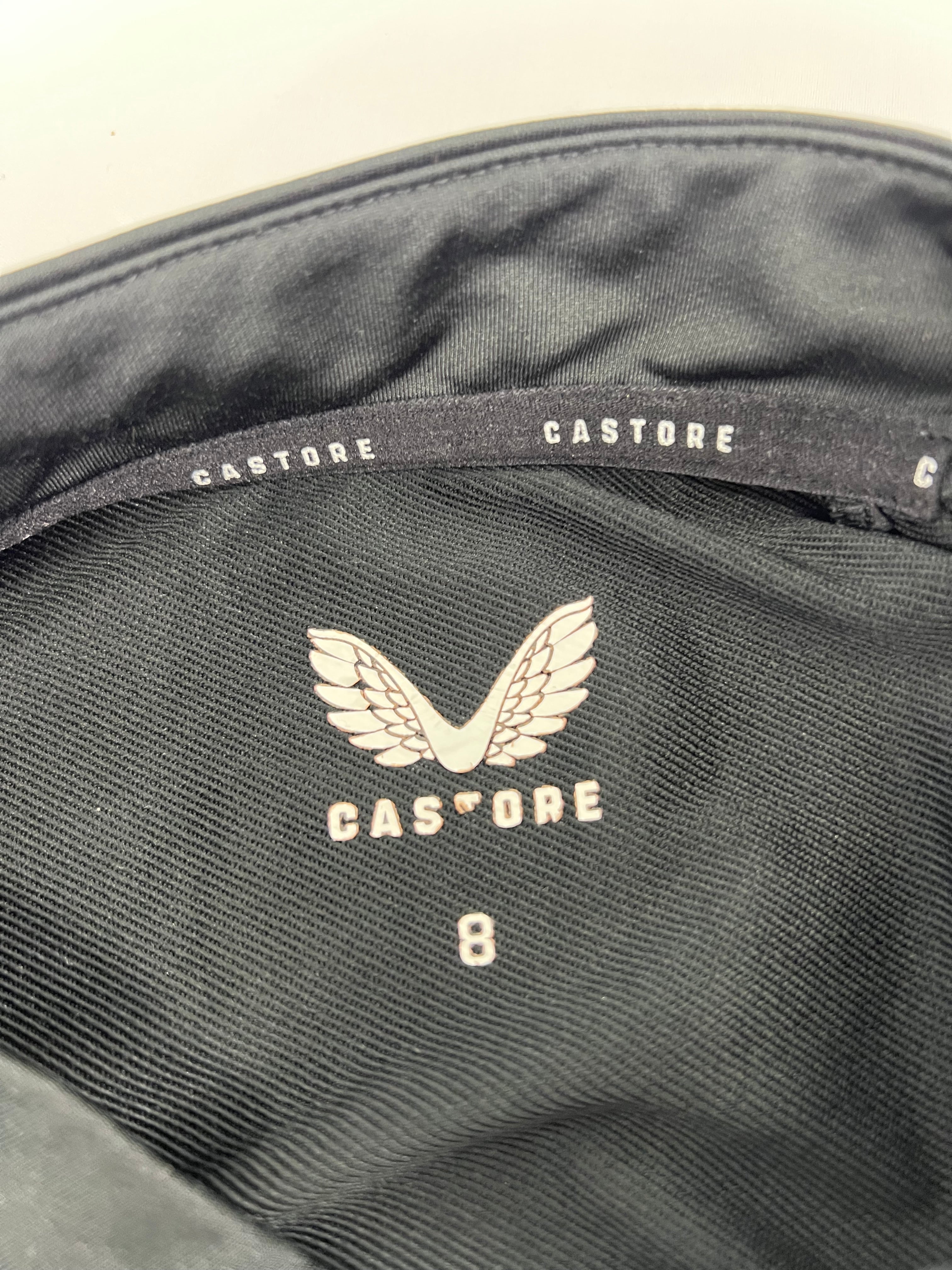 Close-up inside label of Castore Harlequins women's training top showing brand logo and size 8