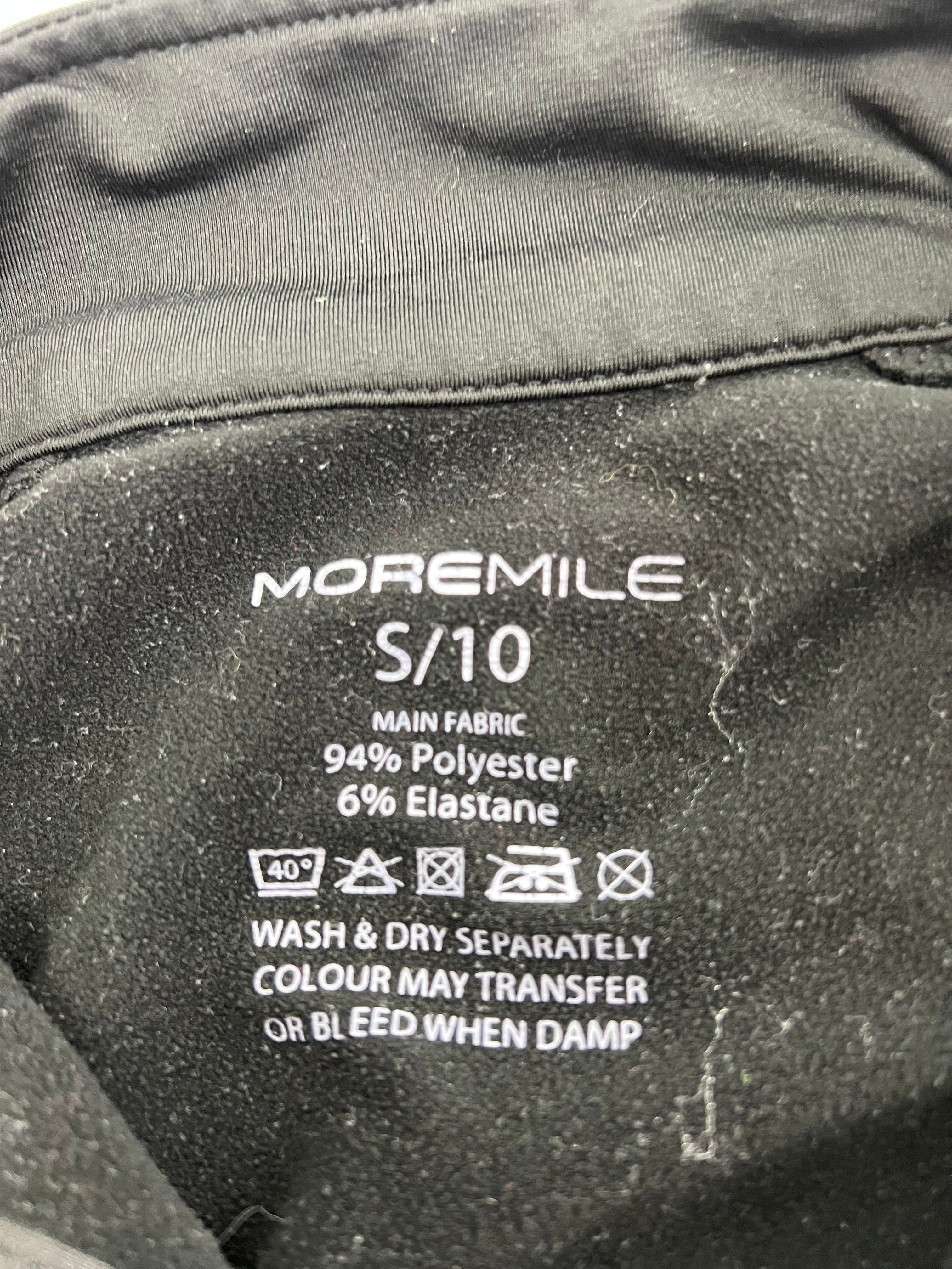 Close-up of fabric care label showing 94% polyester 6% elastane material composition