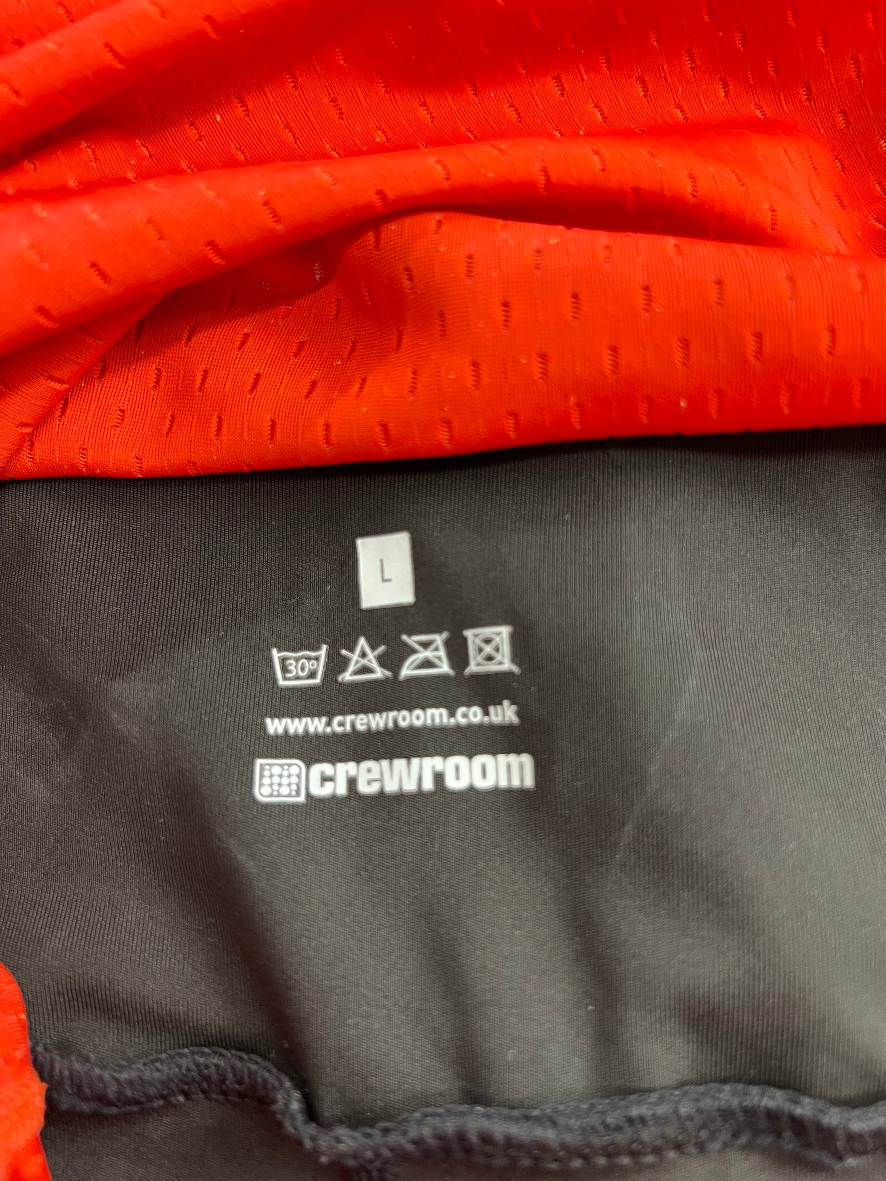Close-up of inner label showing Crewroom brand and care instructions on black fabric