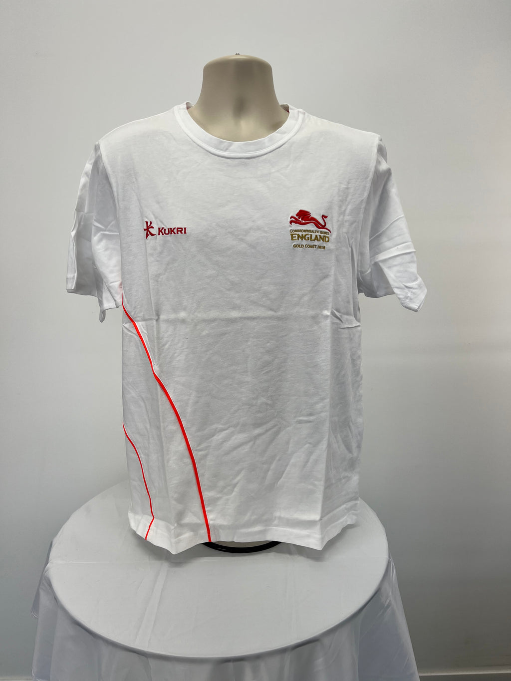 Front view of white Kukri England Commonwealth Games Gold Coast 2018 t-shirt with red logo and design lines