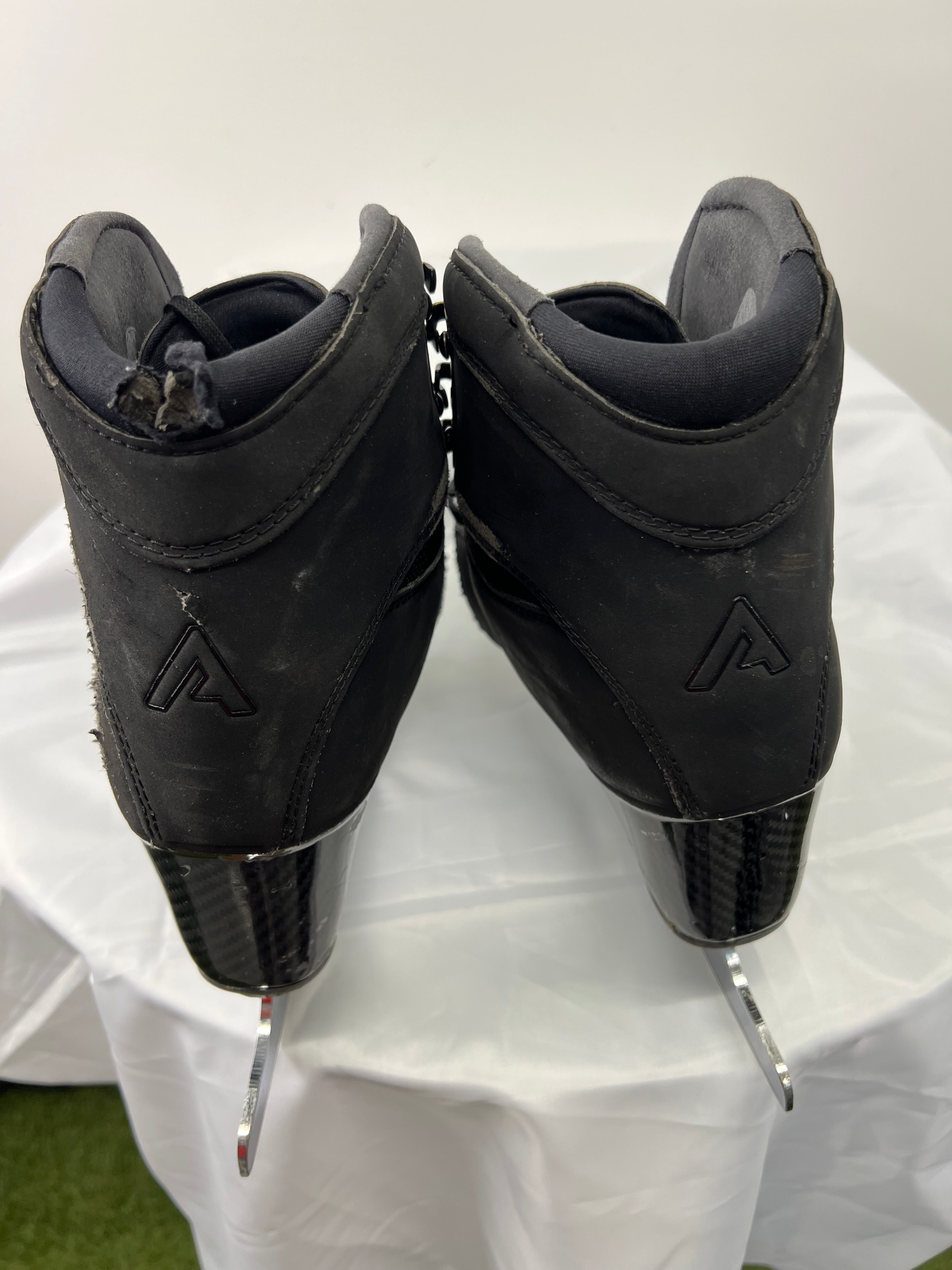 Rear view of Aura boots highlighting carbon fibre heels and logo embossed on back