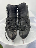 Front view of EDEA Ice Fly figure skates showing black synthetic leather boots with visible wear on toe areas