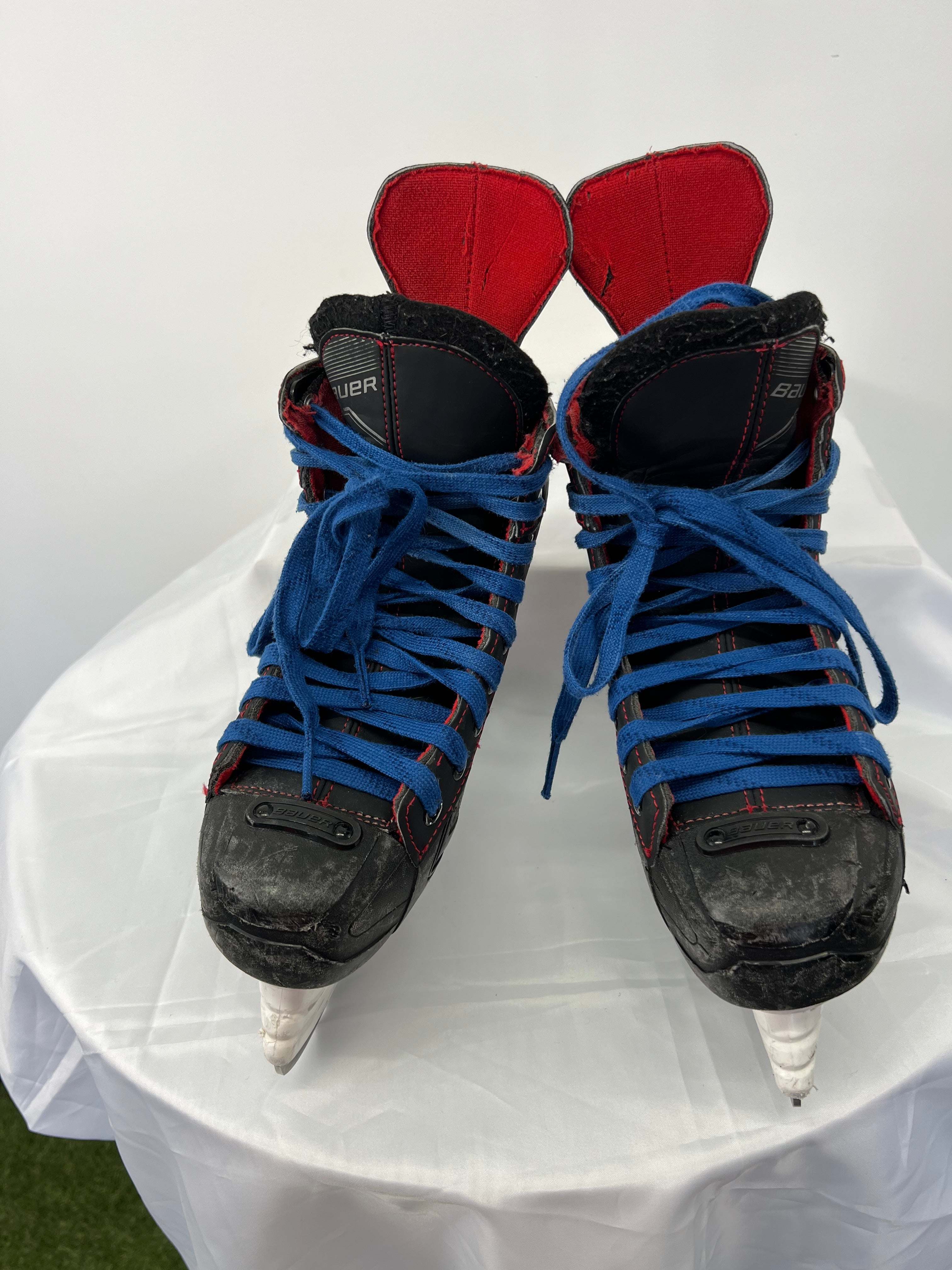 Front view of Bauer Light Speed 11 Pro ice hockey skates with blue laces and red liners