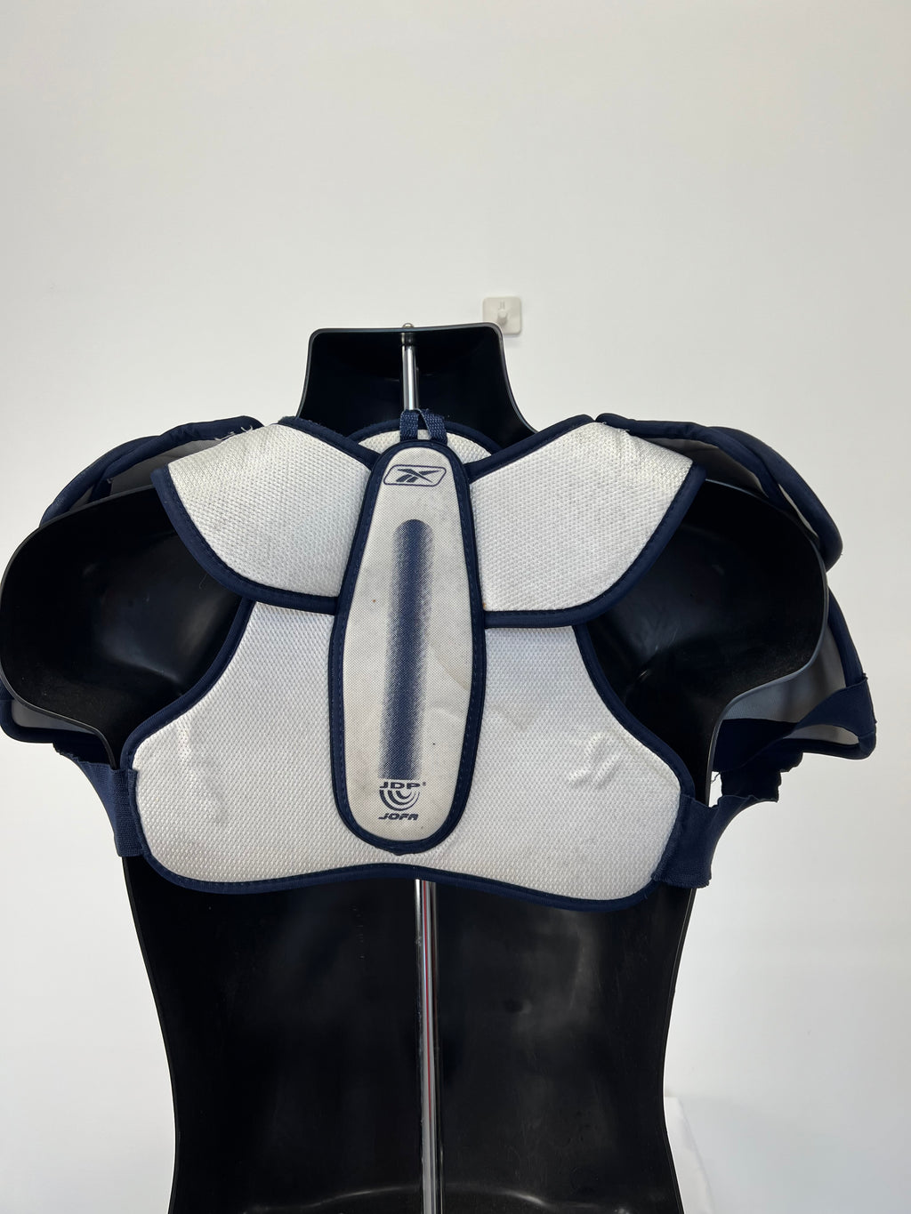 Back view of JOFA NHL White Shield Series ice hockey shoulder pads showing padded design and straps