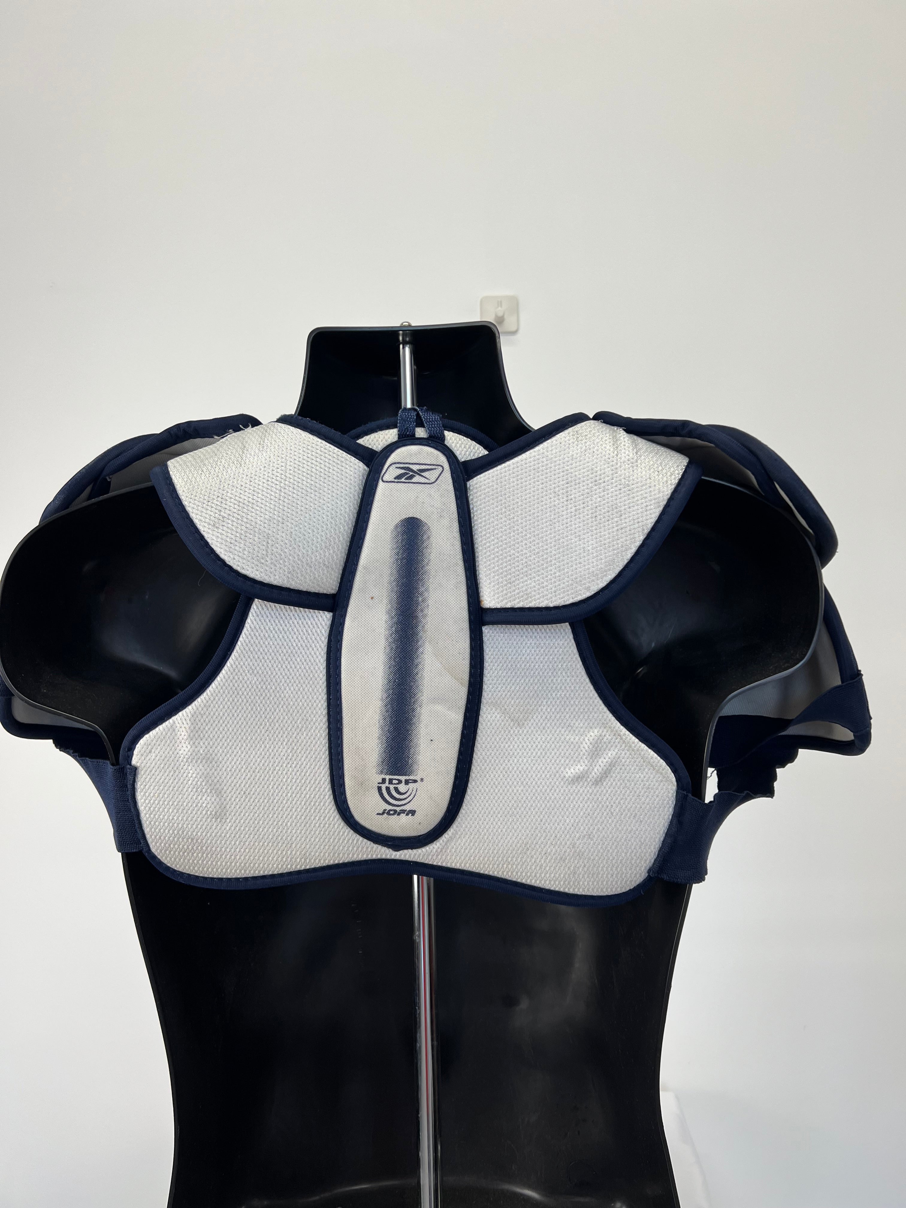Back view of JOFA NHL White Shield Series ice hockey shoulder pads showing padded design and straps