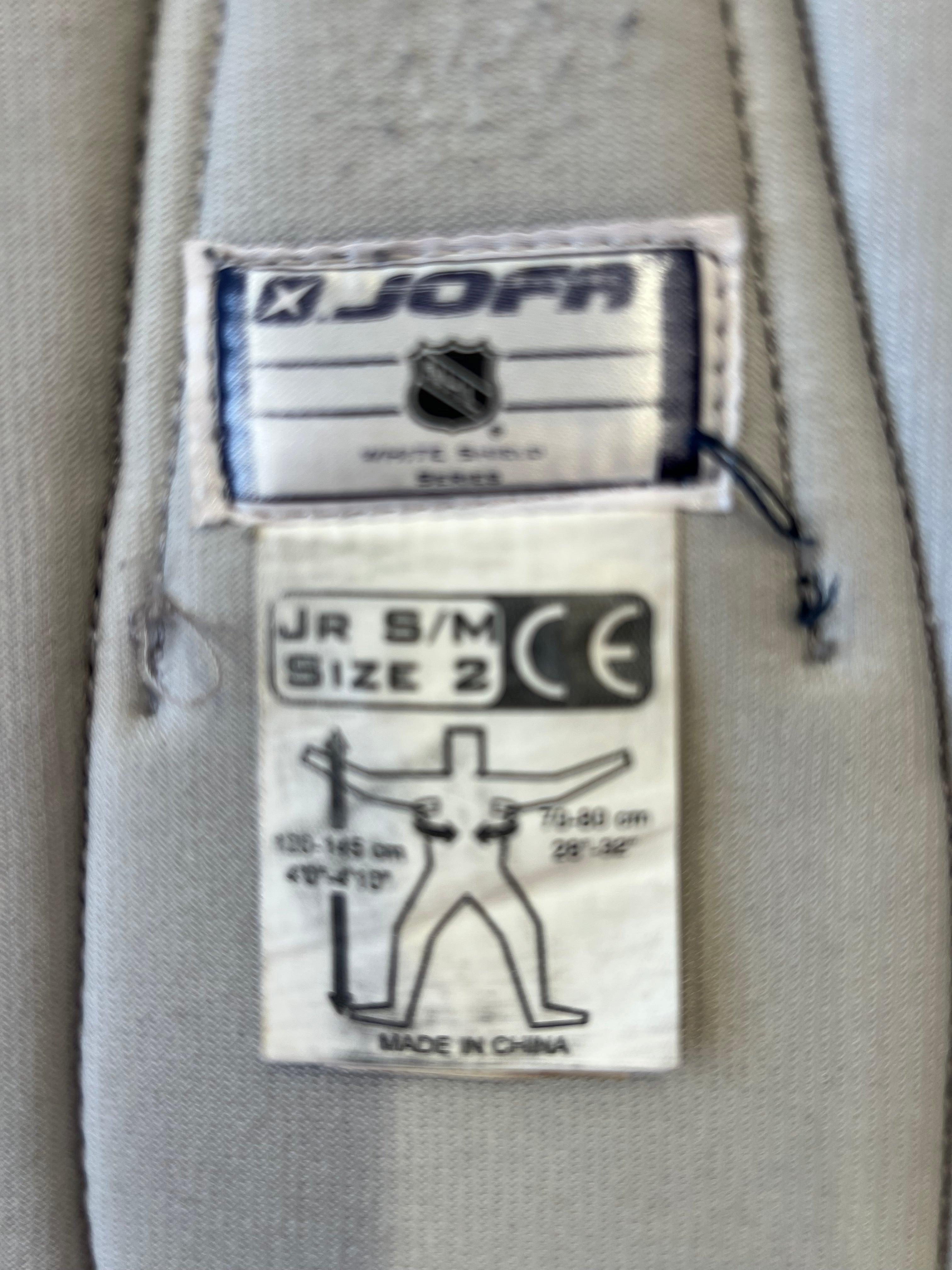 Close-up of JOFA NHL White Shield Series label showing size Jr S/M and product details