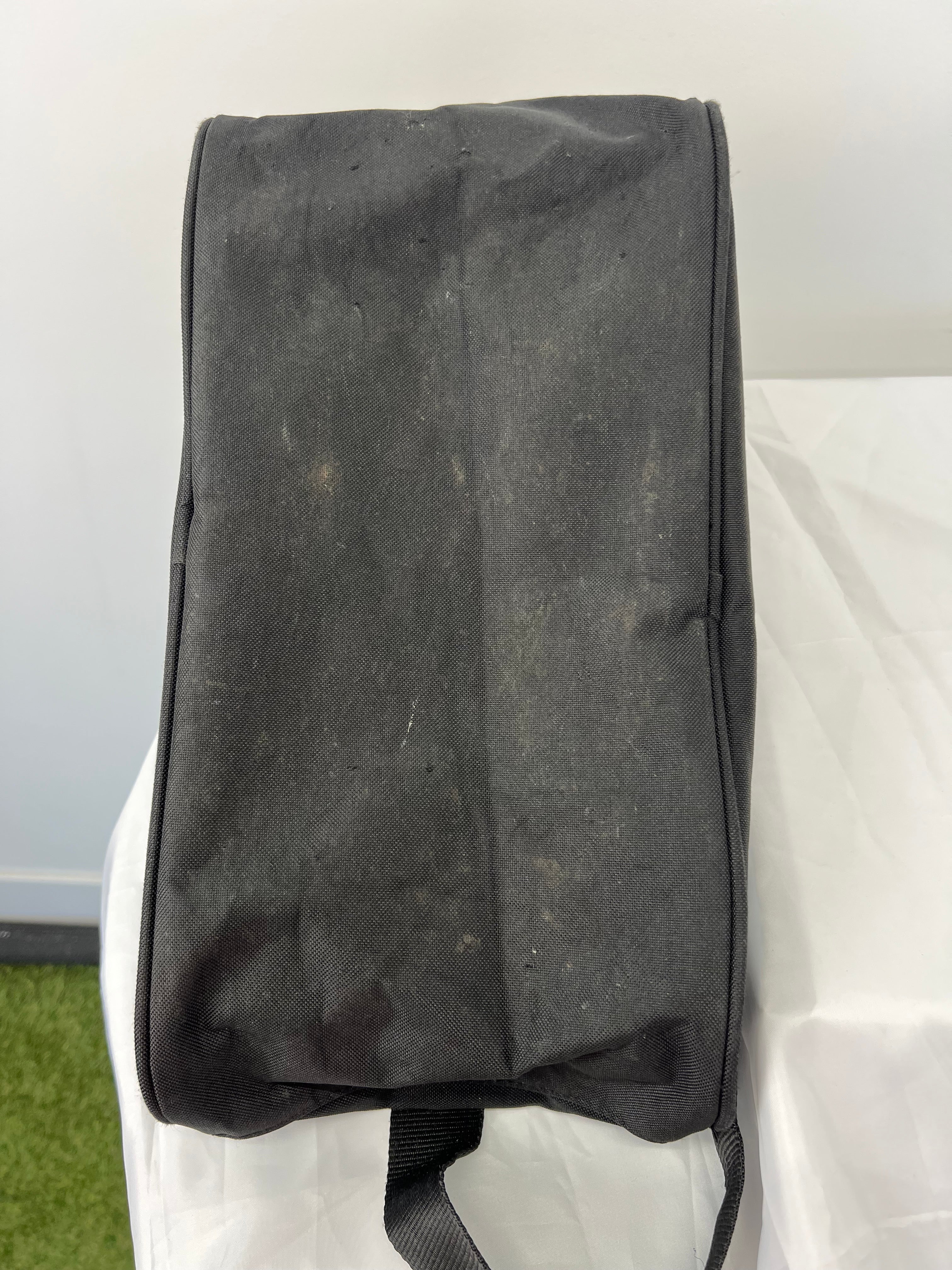 Bottom view of black CCM ice skate bag showing wear marks