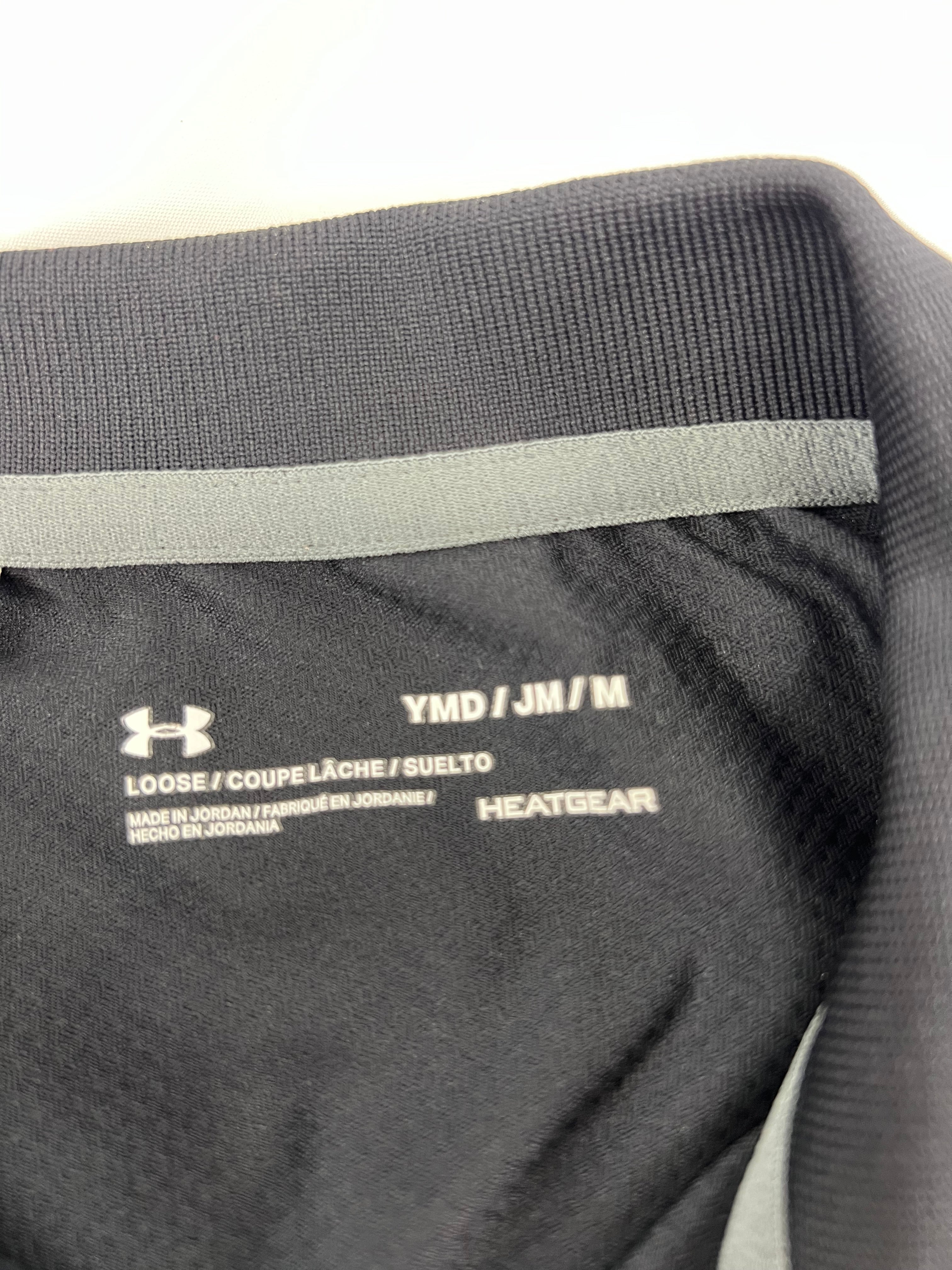 Close-up of inner label showing size and HeatGear branding on black polo