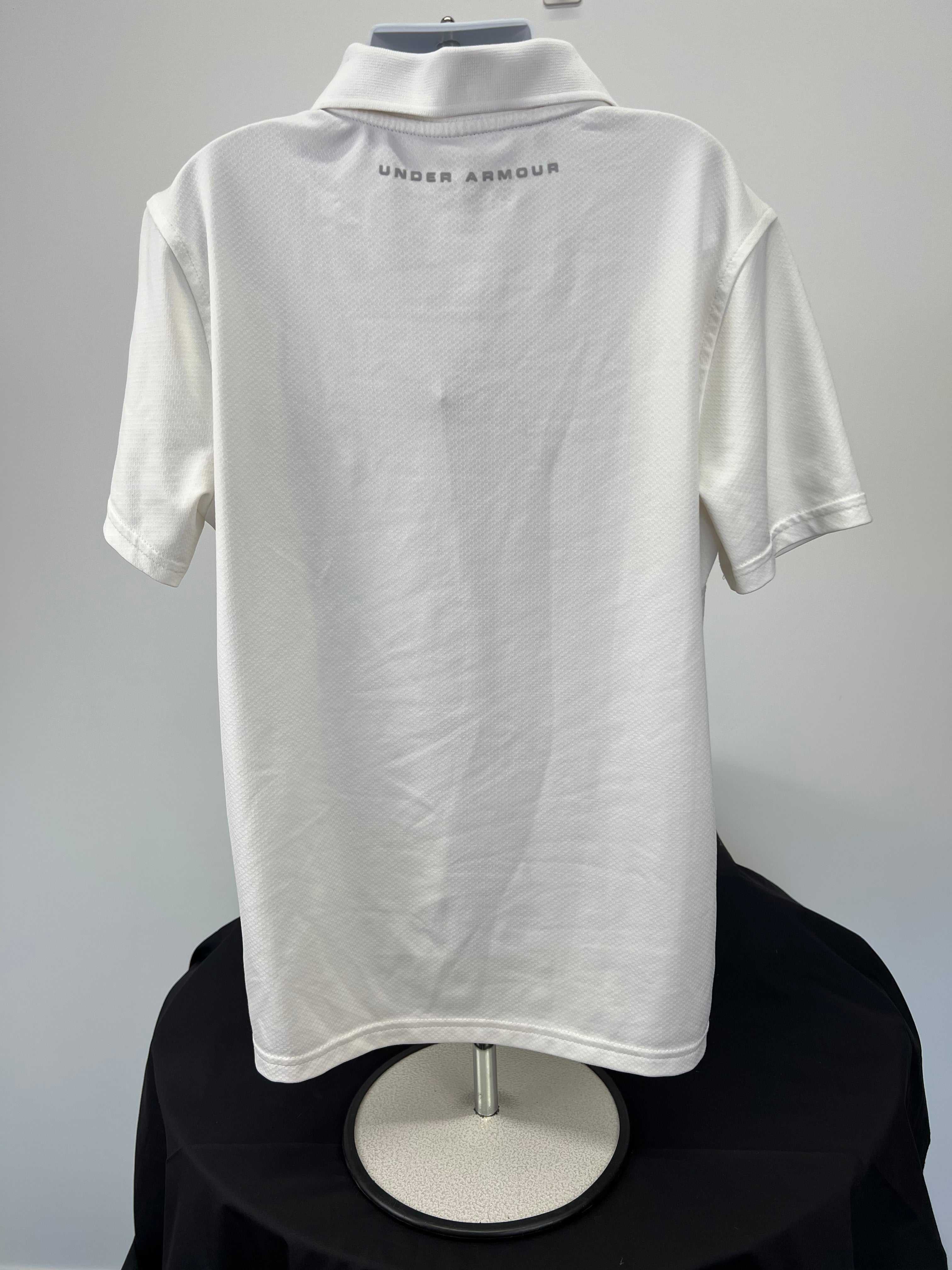 Back view of white Under Armour youth polo shirt with branded text