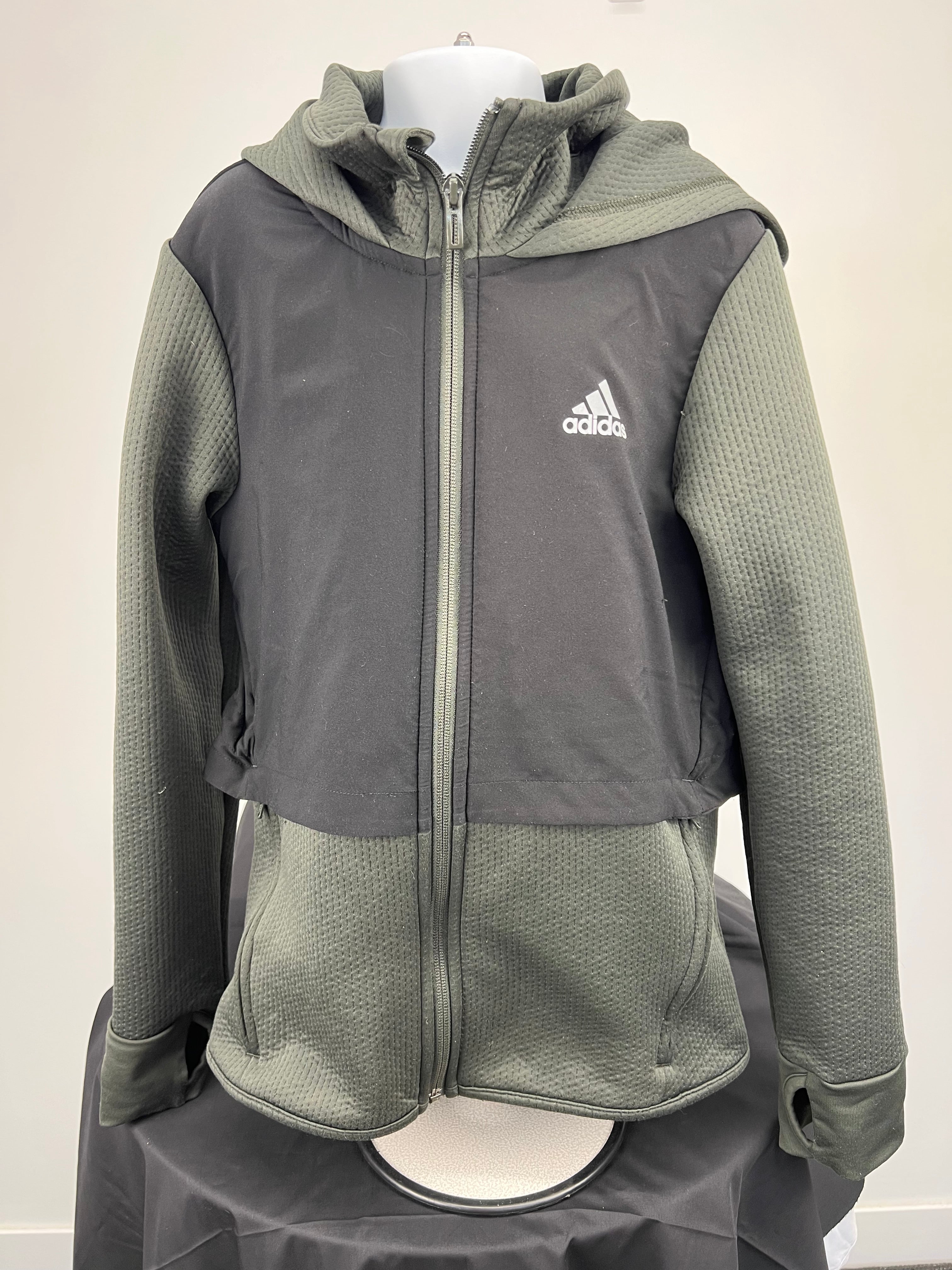 Front view of Adidas Kids Climawarm hooded jacket in green and black with zip and thumbholes