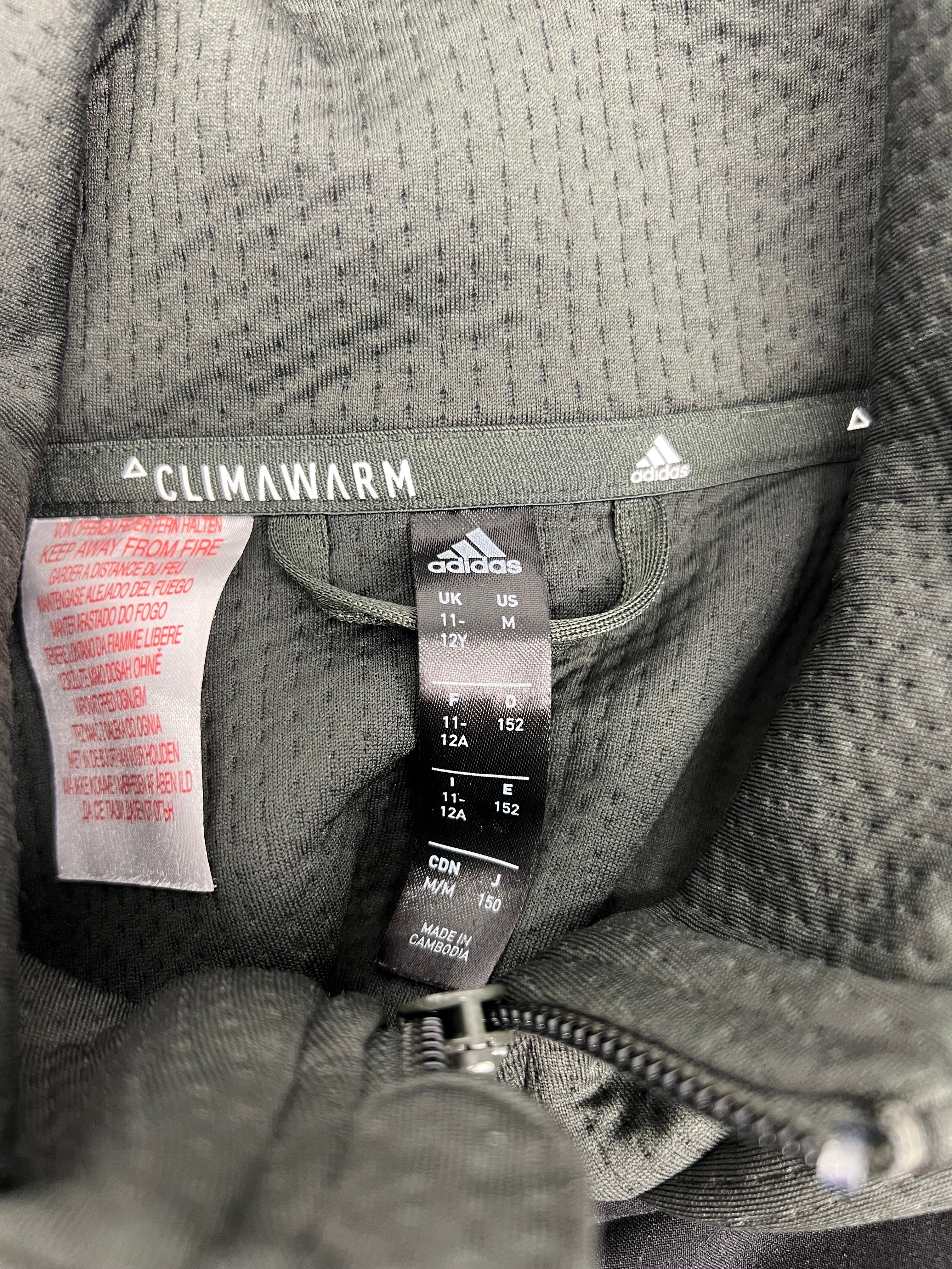 Close-up of Adidas Climawarm size and care label inside the jacket