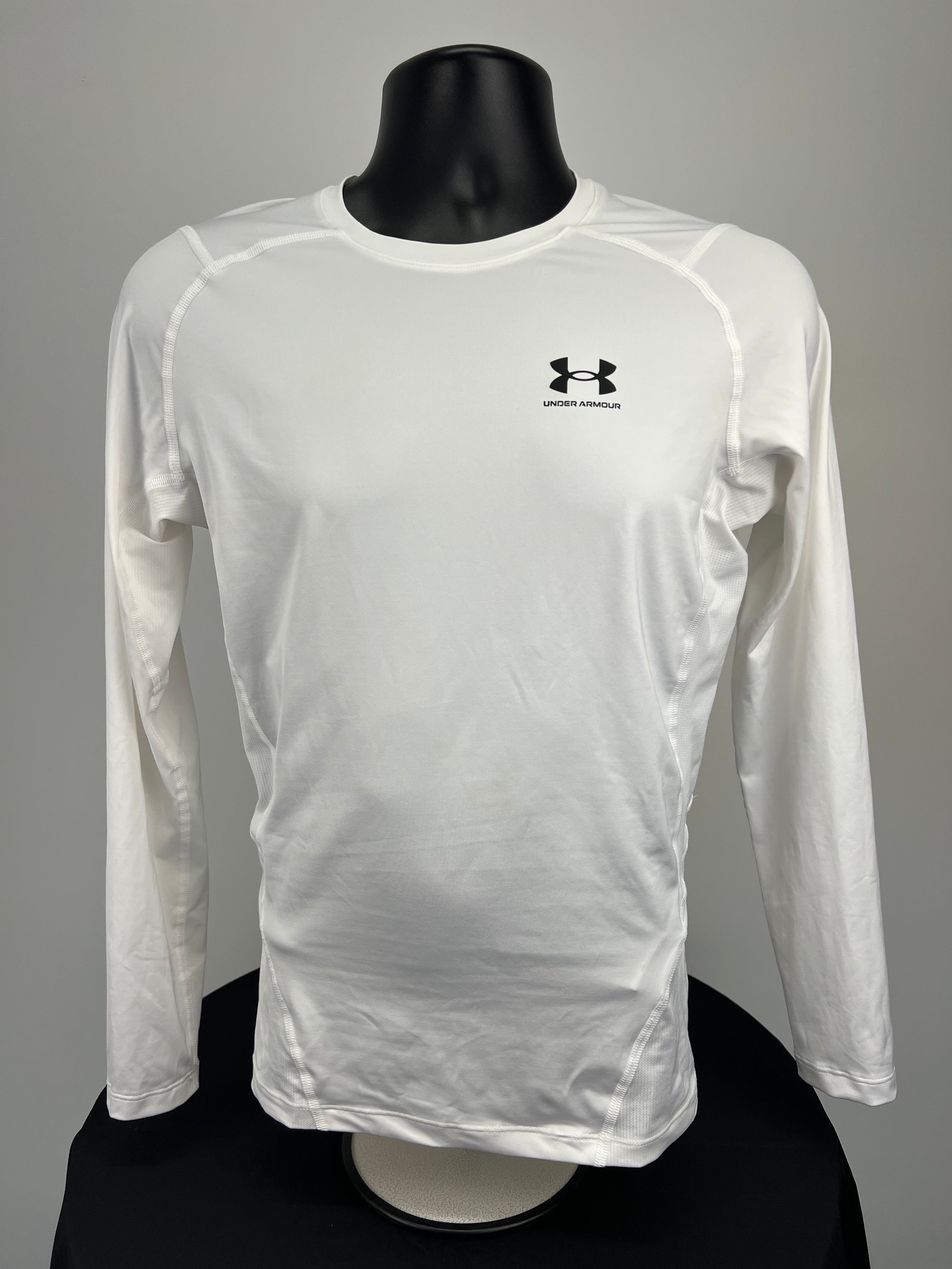 Front view of white Under Armour men’s compression base layer long sleeve shirt with logo on chest