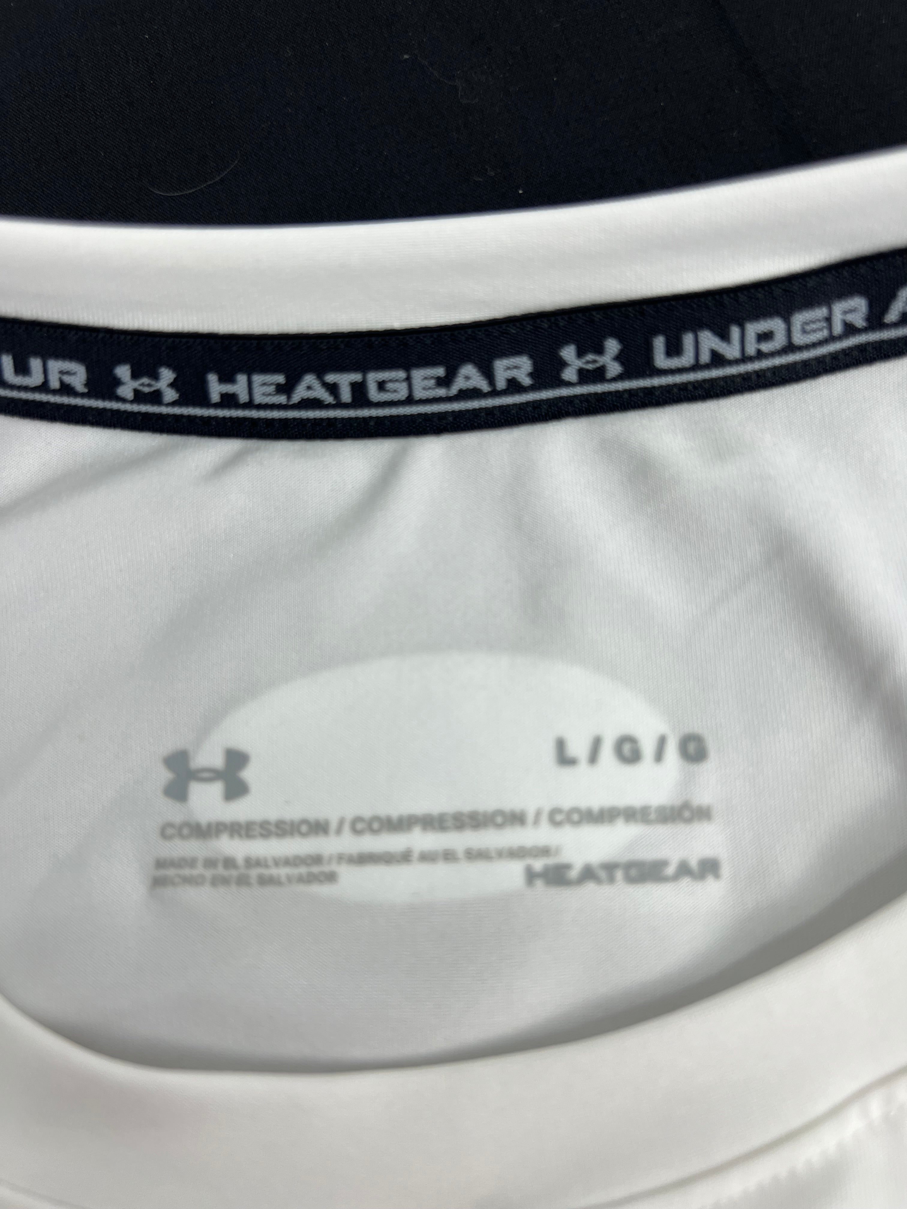 Close-up of the inside neck label showing Under Armour HeatGear compression and size L