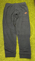 Front view of men’s black Umbro diamond skinny jog pants with orange logo on thigh