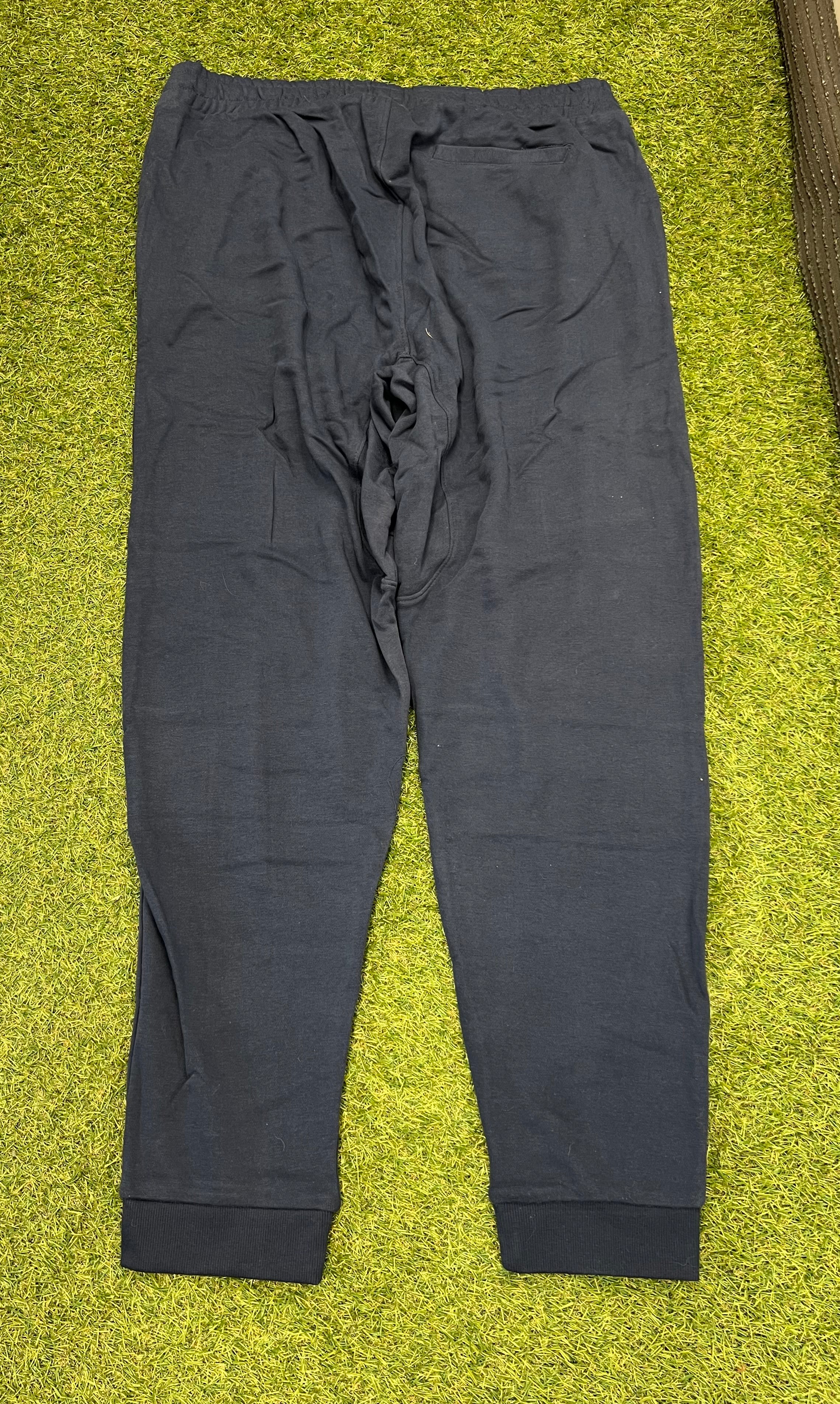 Back view of men’s black Umbro diamond skinny jog pants showing a single back pocket