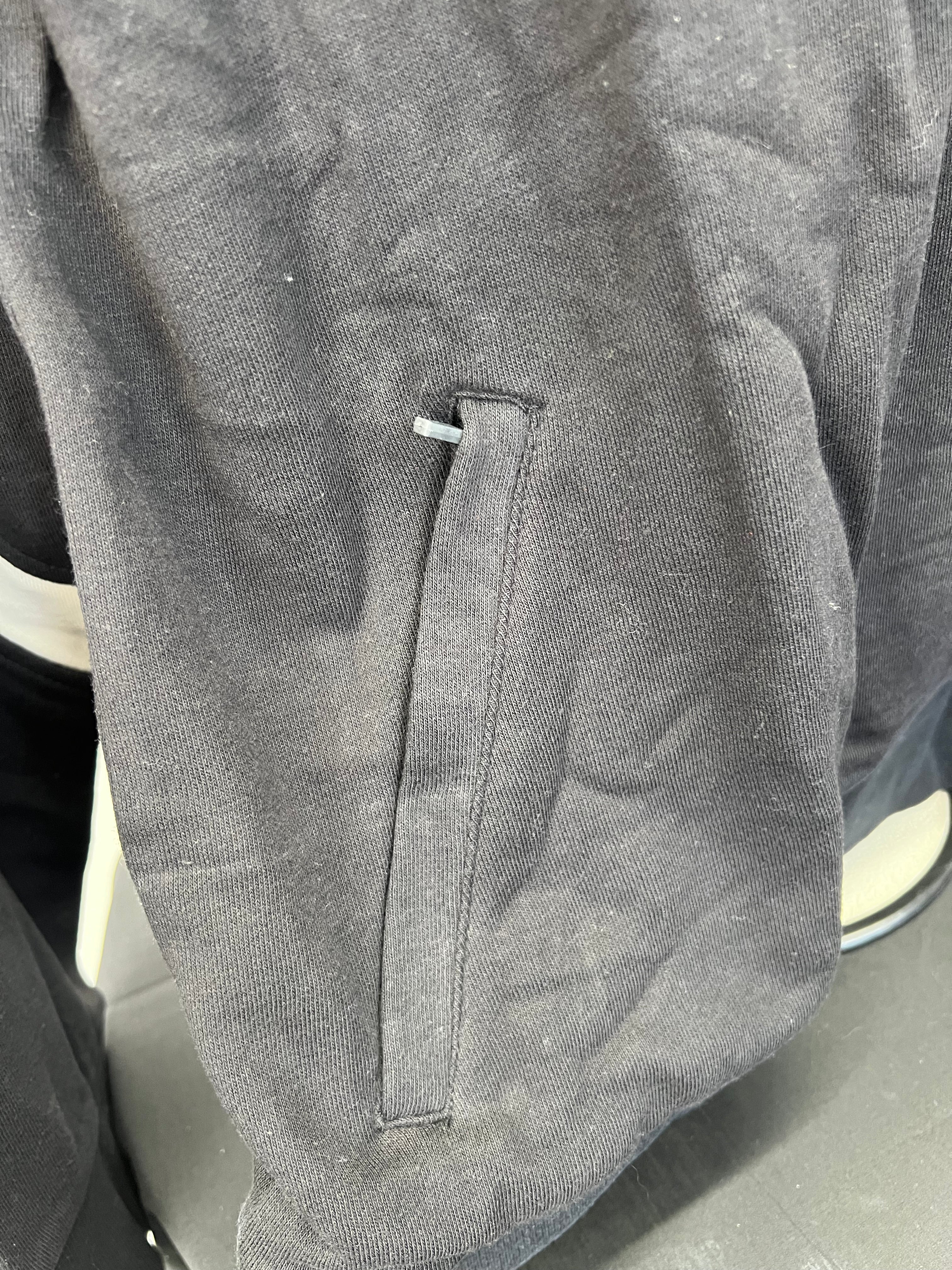 Close-up of side pocket detail on black Umbro sweatshirt