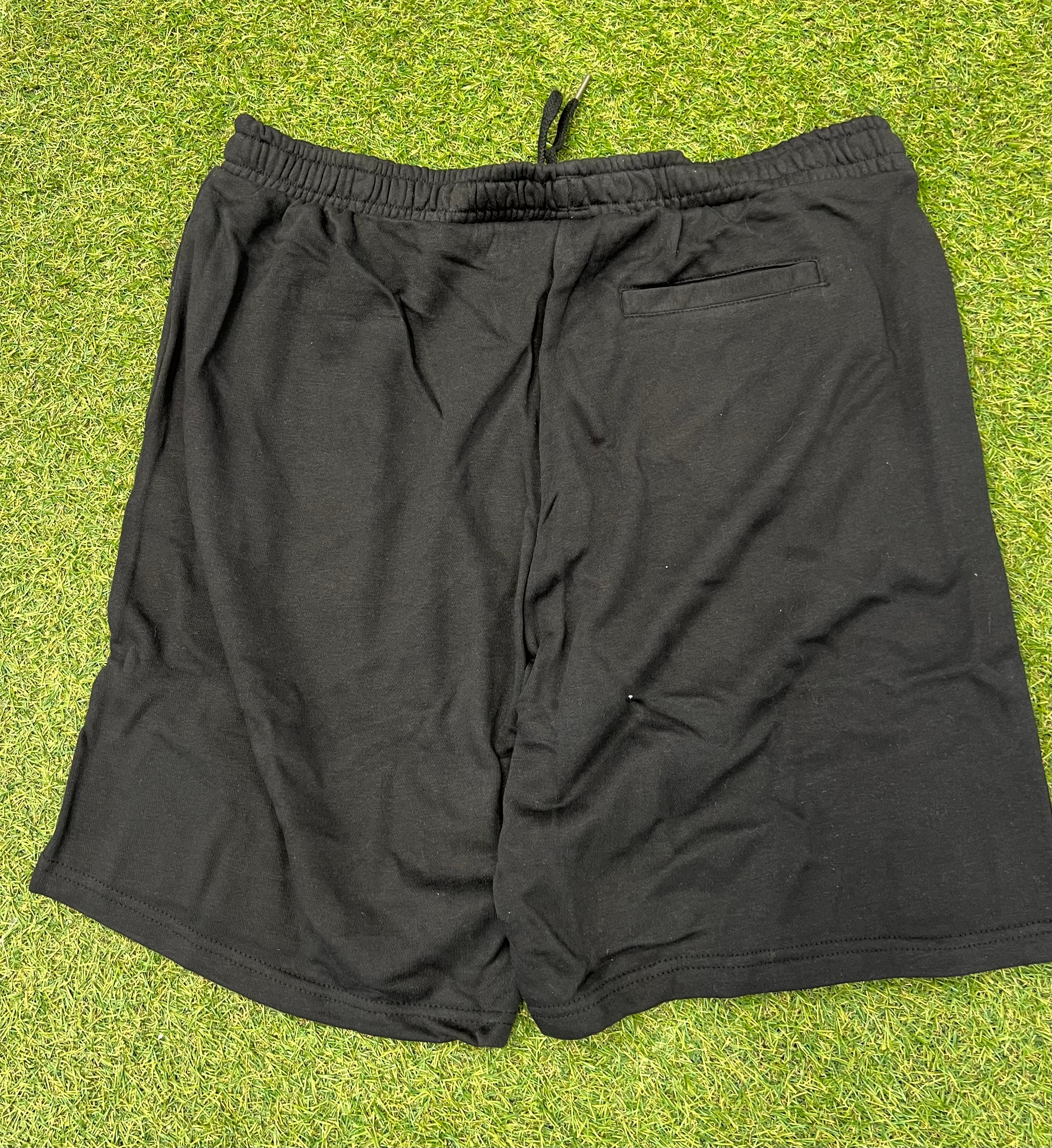 Rear view of black Umbro Diamond Jog Shorts showing back pocket and elastic waistband