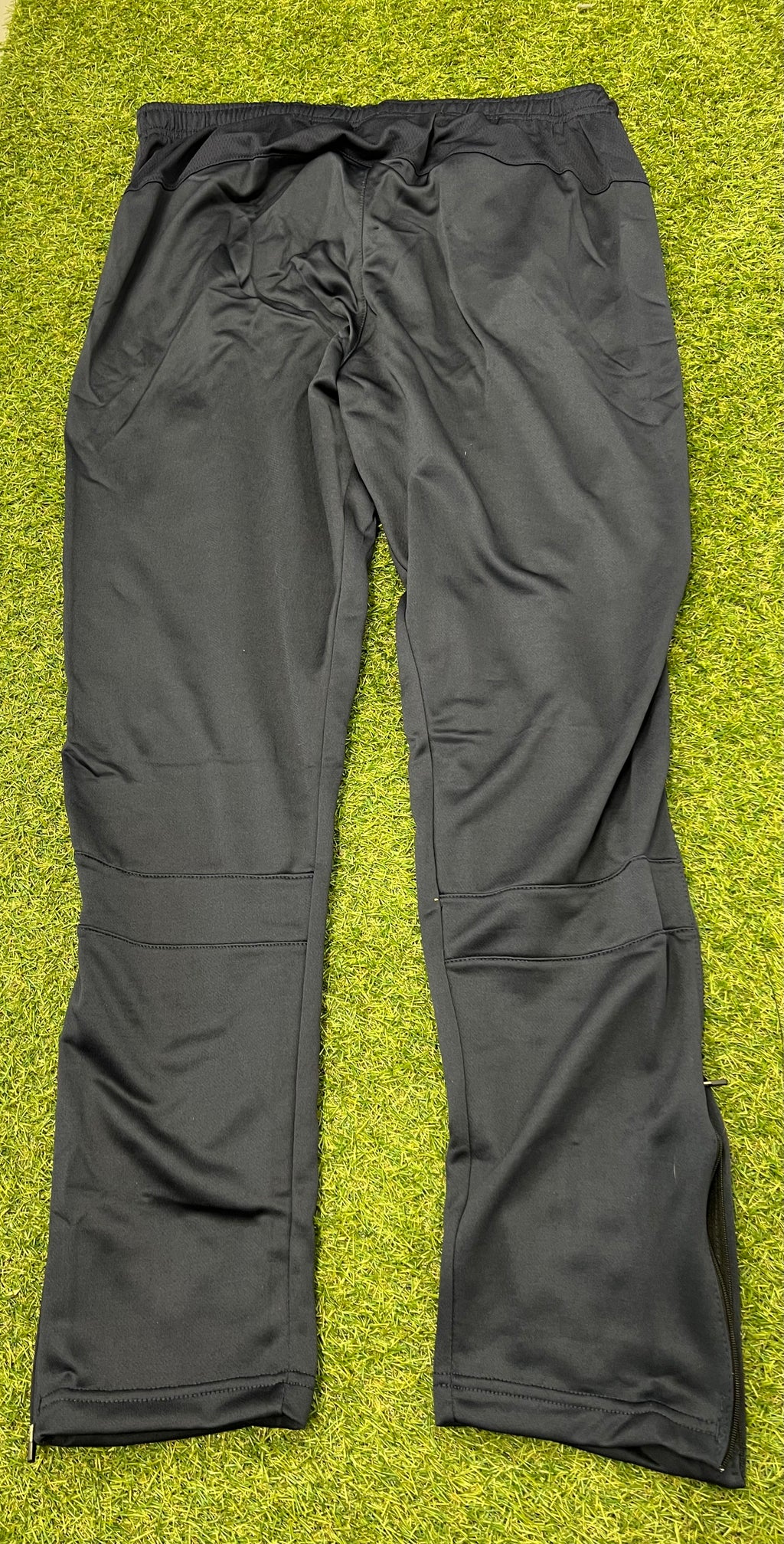 Back view of London Irish BLK black tracksuit trousers with smooth fabric and elastic waistband